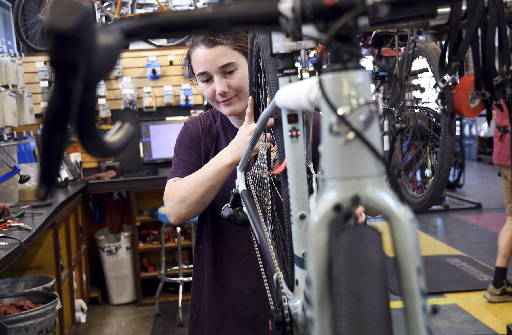 Mechanic Lizzy Thomson works at University Bicycles in Boulder, Colo., Tuesday, April 30, 2024. Bike stores quickly sold out of their stock early in the pandemic and had trouble restocking because of supply chain issues. Now, inventory is back, but demand has waned. (AP Photo/Thomas Peipert)    PHOTO CREDIT: Associated Press