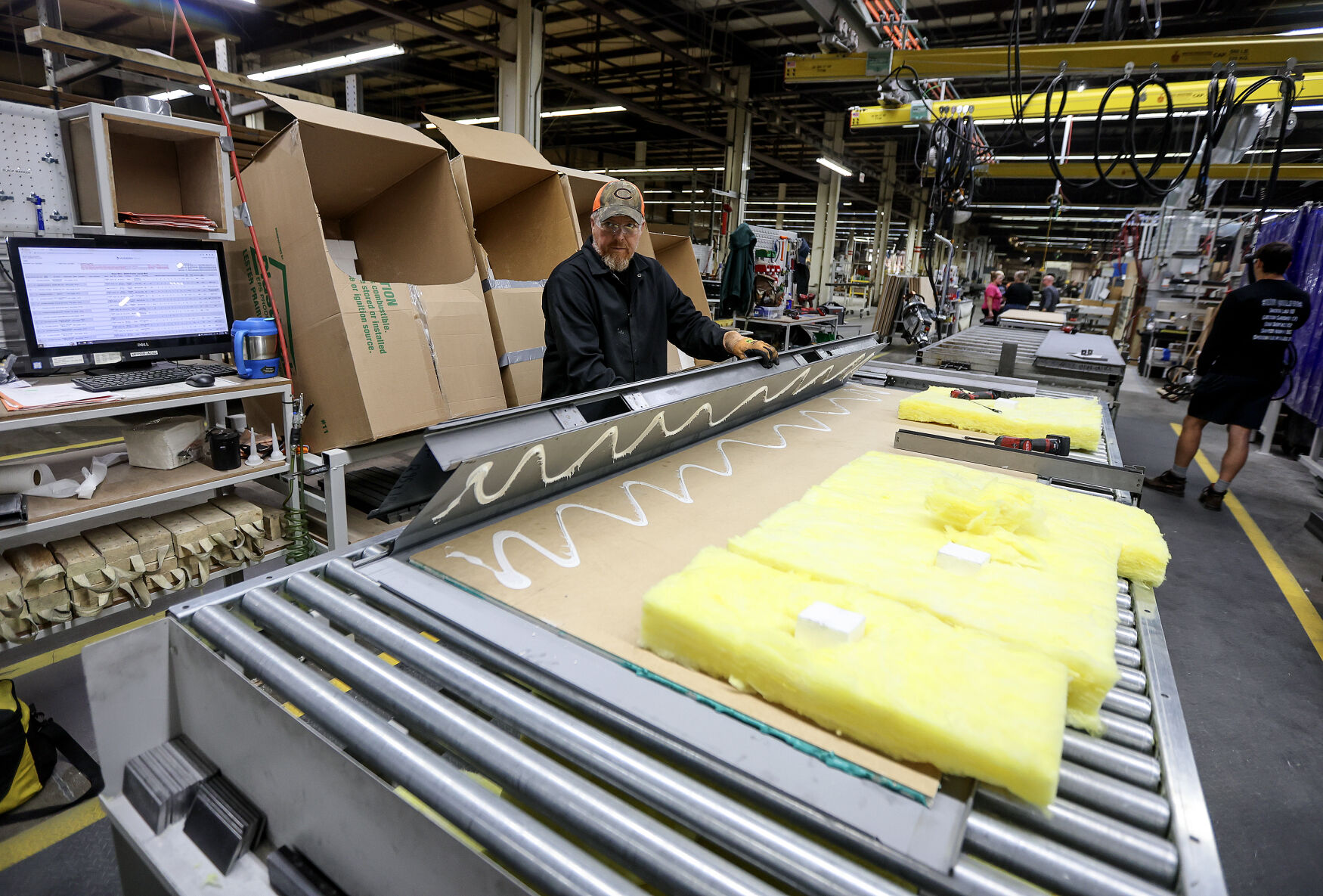 Modernfold employee Mike Ernzen works on putting together a product on one of the many assembly lines at the Dyersville, Iowa, plant recently.    PHOTO CREDIT: Dave Kettering