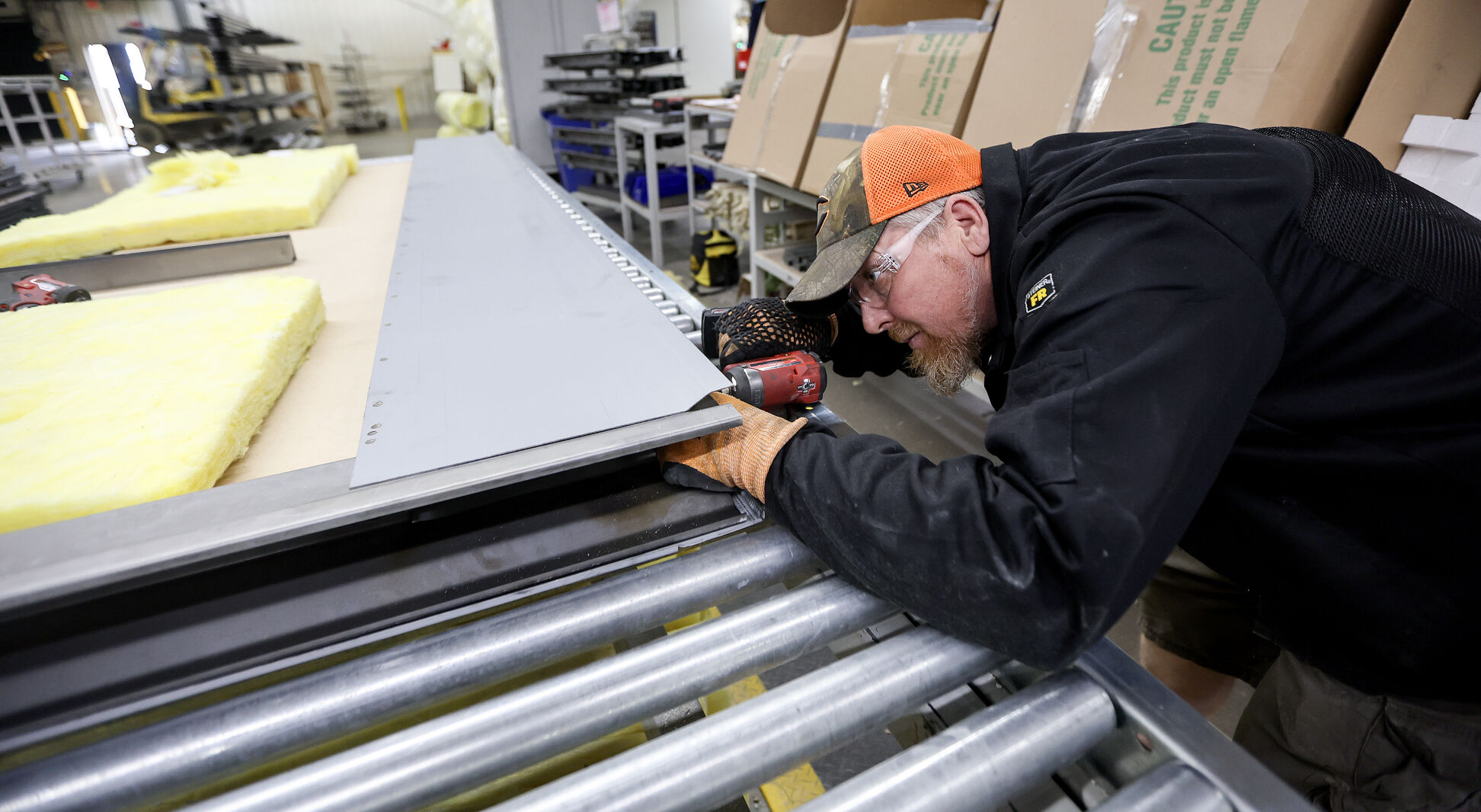Employee Mike Ernzen puts together a product.    PHOTO CREDIT: Dave Kettering