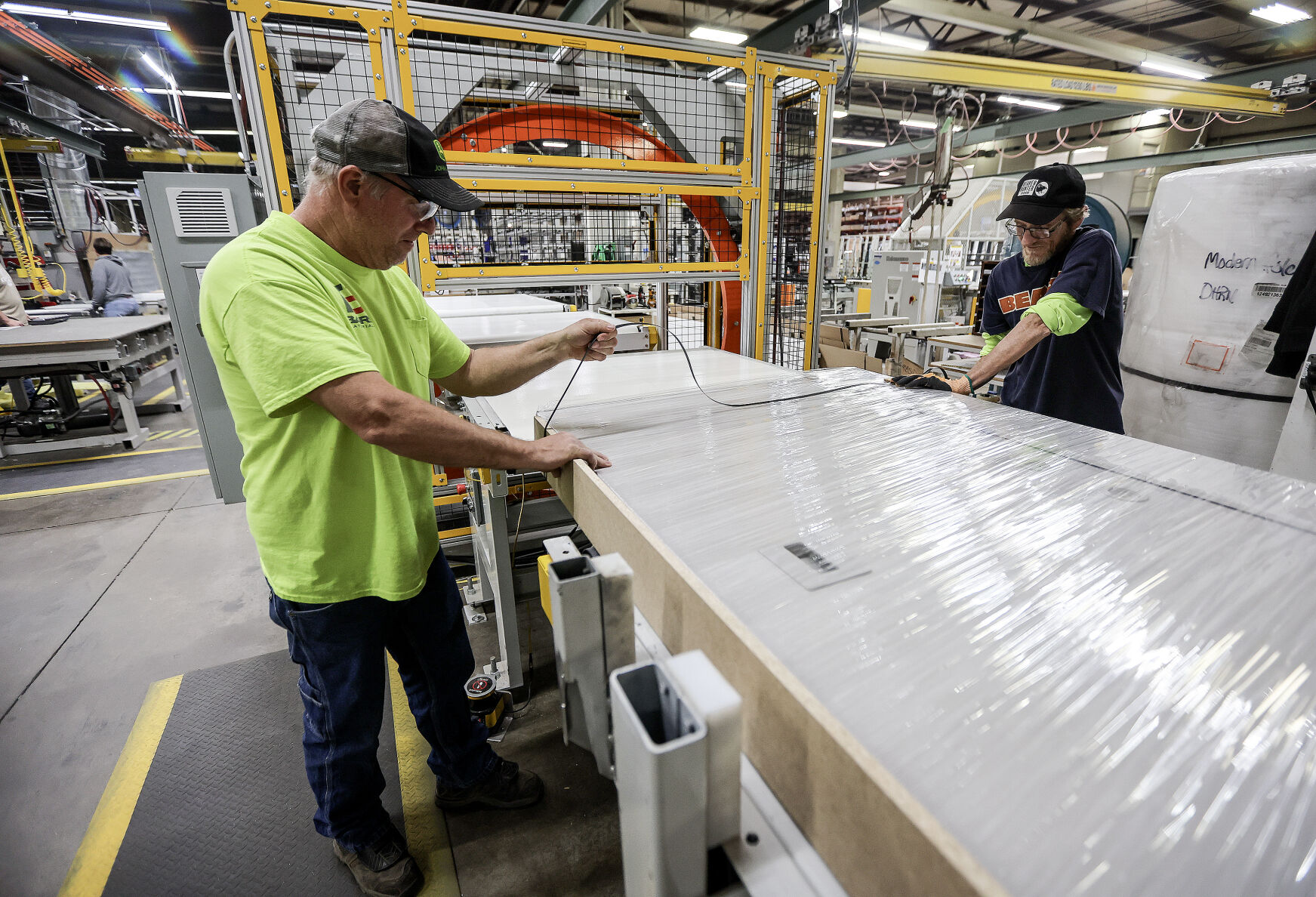 Modernfold employees Steve Burlage (left) and Joe Krapfl work on shipping a finished product on one of the assembly lines at the Dyersville, Iowa, plant.    PHOTO CREDIT: Dave Kettering Telegraph Herald