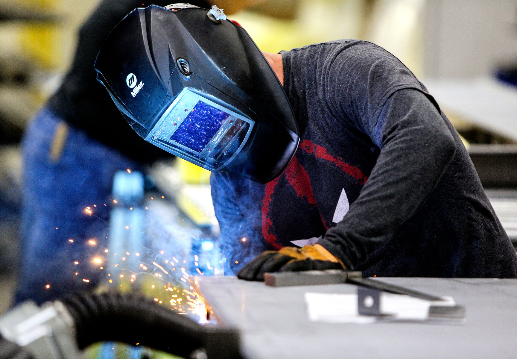 Modernfold employee Chris Phillips welds a product.    PHOTO CREDIT: Dave Kettering Telegraph Herald