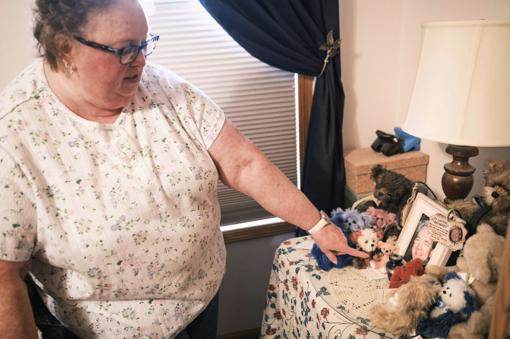 <p>Nancy Gag Braun points to a small urn holding the ashes of her late husband Steve Braun, in her Mankato, Minn., bedroom on May 13, 2024. After caring for Steven at home became too much for her to handle, he was at the hospital while they waited on a long-term care placement. “I cried many nights,” Braun said. “I felt so guilty.” (Casey Ek/CNHI News via AP)</p>   PHOTO CREDIT: Casey Ek 