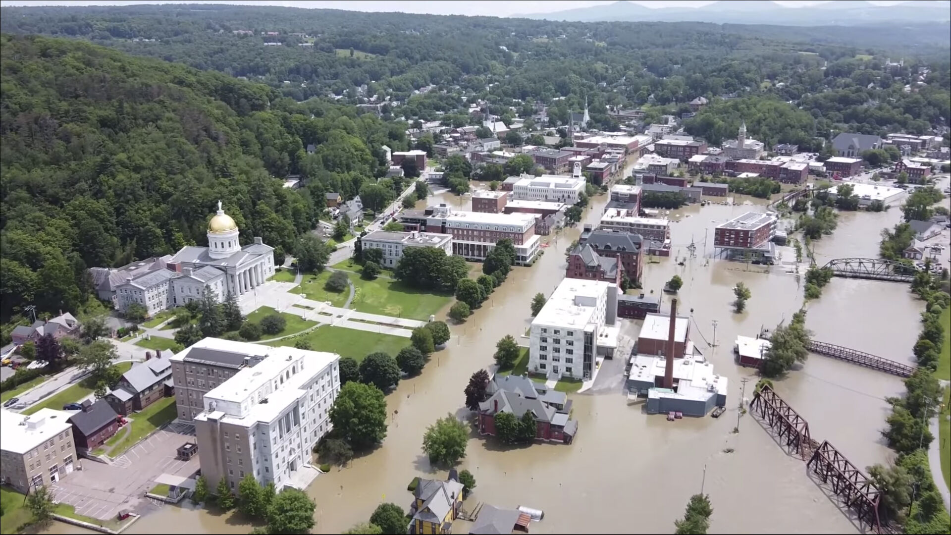 <p>FILE - This image made from drone footage provided by the Vermont Agency of Agriculture, Food and Markets shows flooding in Montpelier, Vt., Tuesday, July 11, 2023. Vermont has become the first state to enact a law requiring fossil fuel companies to pay a share of the damage caused by climate change, Thursday, May 30, 2024 after the state suffered catastrophic summer flooding and damage from other extreme weather. (Vermont Agency of Agriculture, Food and Markets via AP)</p>   PHOTO CREDIT: Uncredited - hogp, ASSOCIATED PRESS