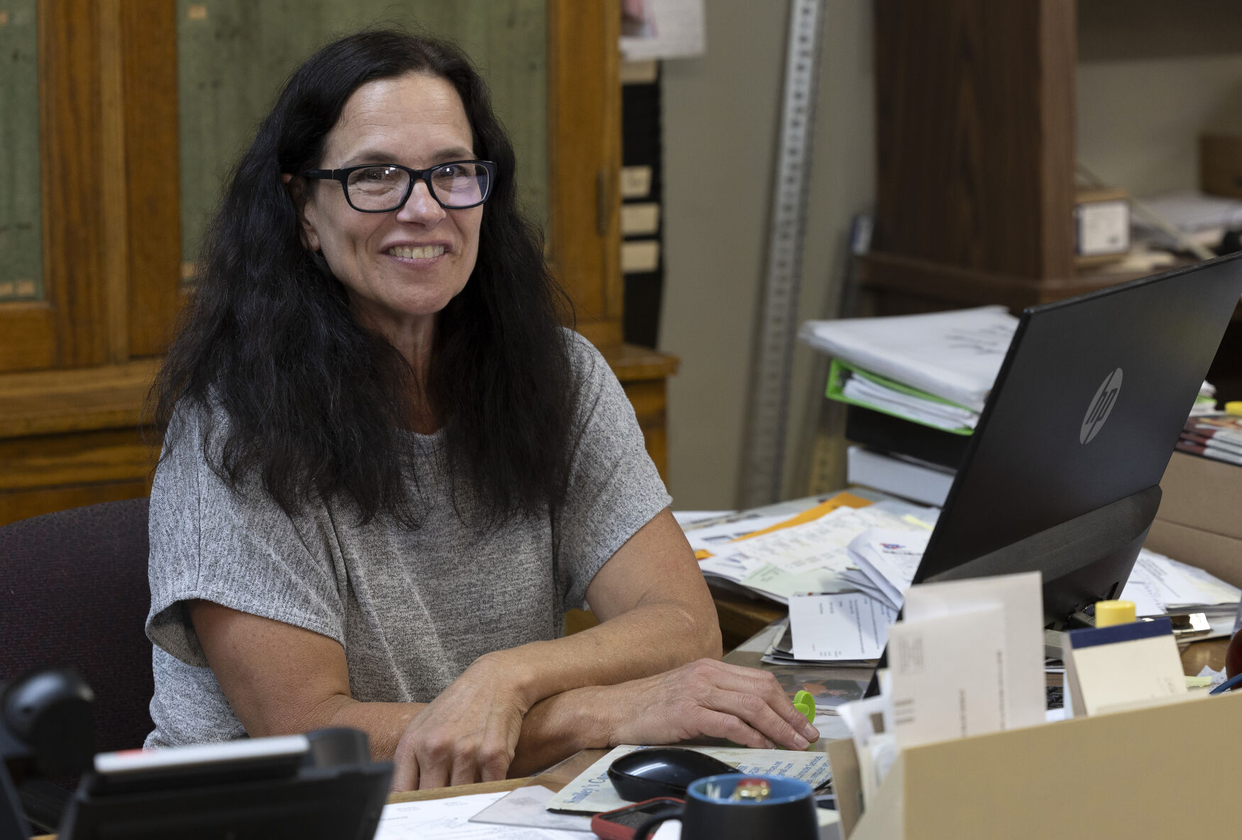 Lue Bockenstedt at her desk in Ungs Shopping Center in Luxemburg, Iowa.    PHOTO CREDIT: Stephen Gassman
Telegraph Herald