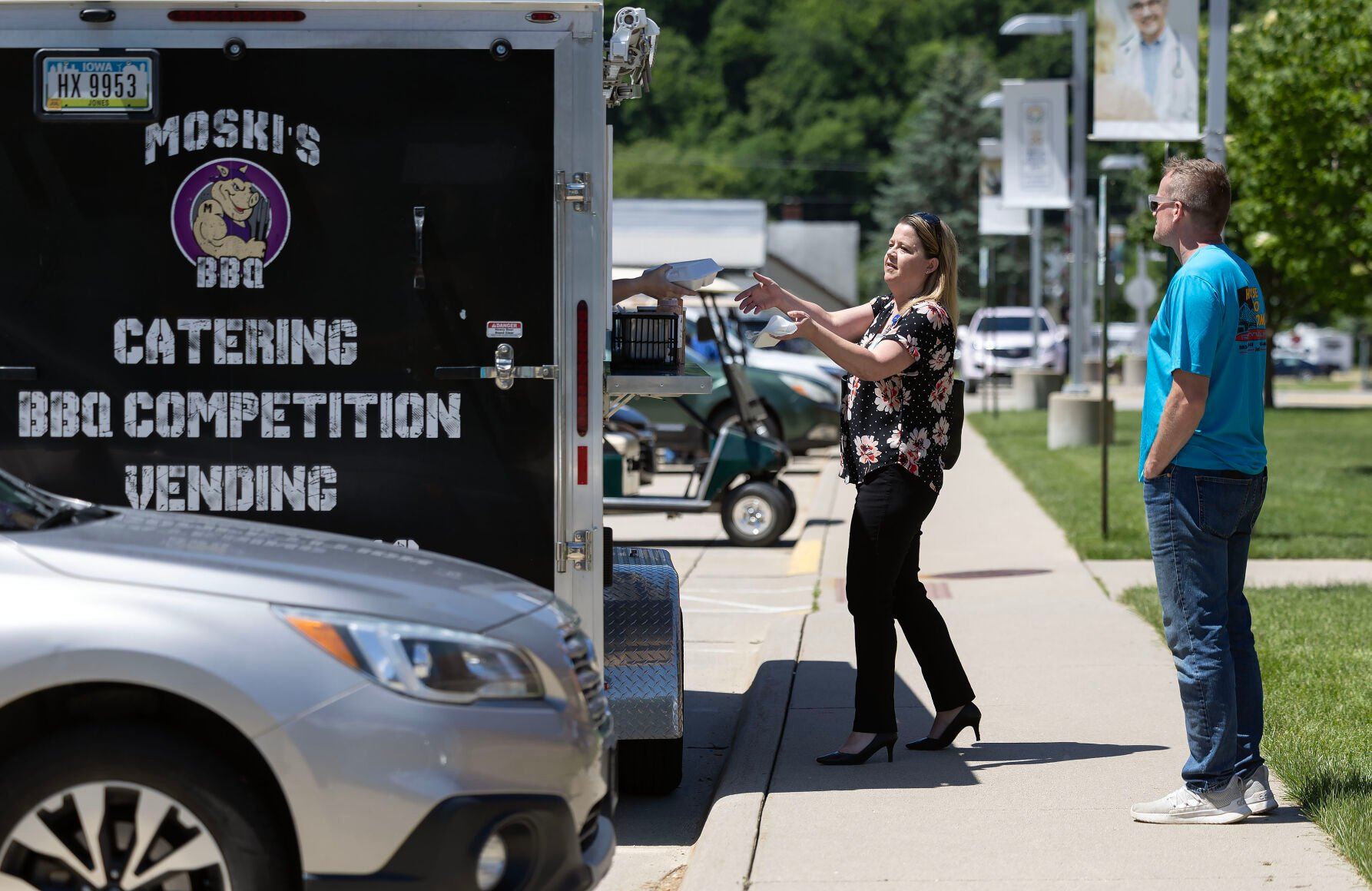 Customers wait for their orders at Moski’s BBQ food truck while it was parked in Guttenberg, Iowa, last week.    PHOTO CREDIT: Stephen Gassman