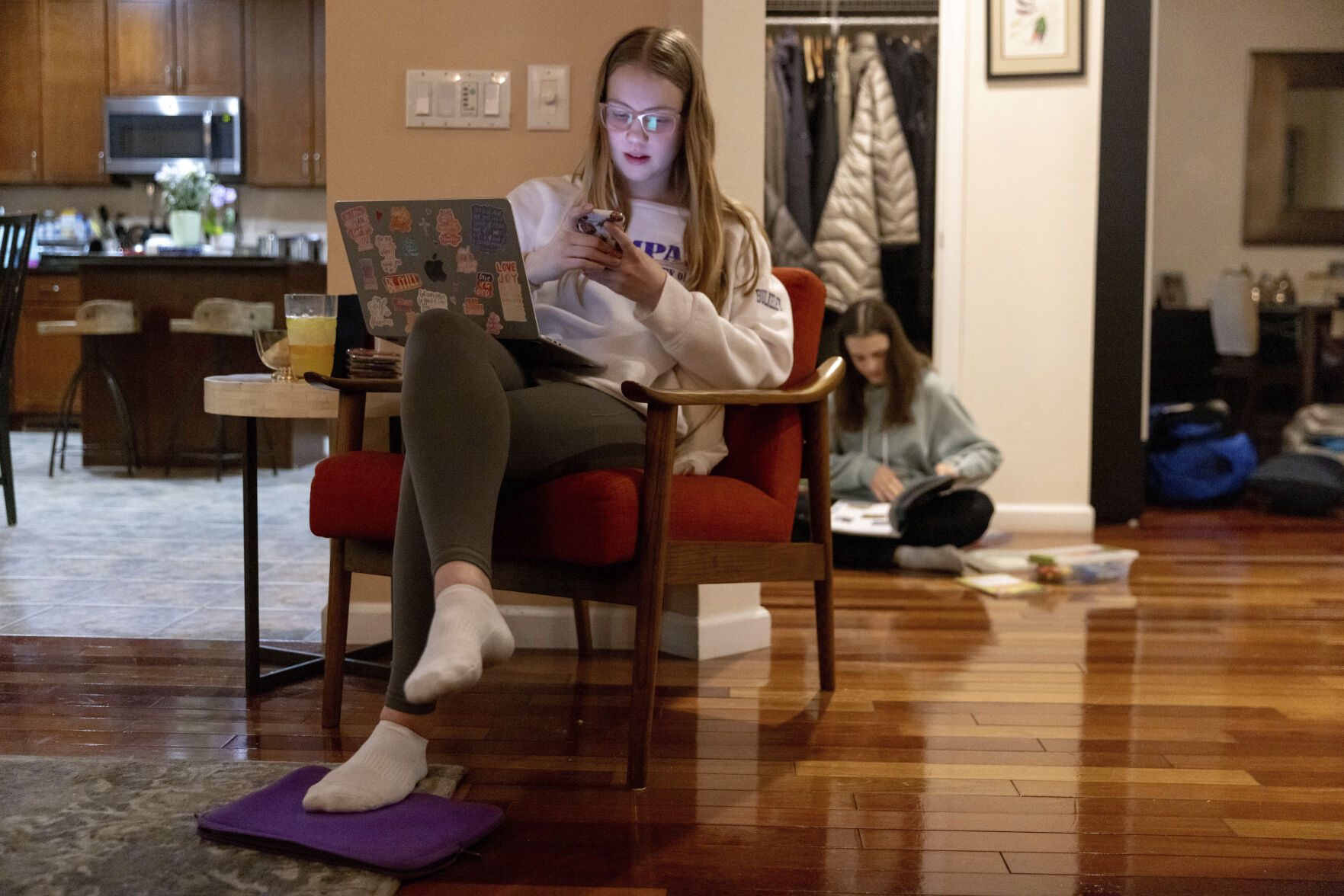 <p>Kate Bulkeley uses her phone to print textbook pages while Sutton packs art materials ahead of a ski vacation, Friday, Feb. 16, 2024, in Westport, Conn. It is hard to be a teenager today without social media. For those trying to stay off social platforms at a time when most of their peers are immersed, the path can be challenging, isolating and at times liberating. It can also be life-changing. (AP Photo/Julia Nikhinson)</p>   PHOTO CREDIT: Julia Nikhinson