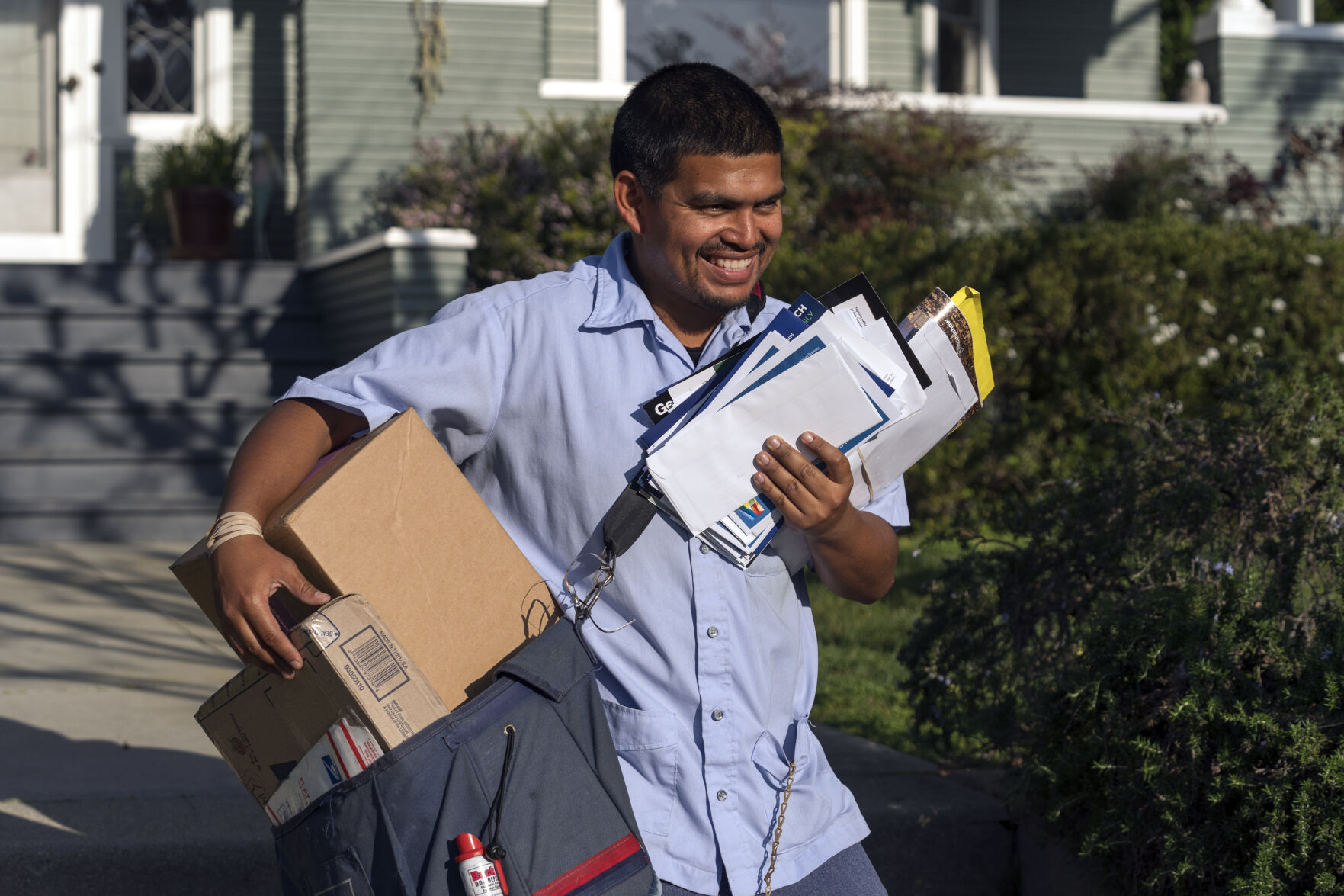 <p>FILE - United States Postal Service letter carrier Gabriel Peña carries mail in Los Angeles on March 22, 2024. On Friday, June 7, 2024, the U.S. government issues its May jobs report. (AP Photo/Damian Dovarganes, File)</p>   PHOTO CREDIT: Damian Dovarganes - staff, ASSOCIATED PRESS