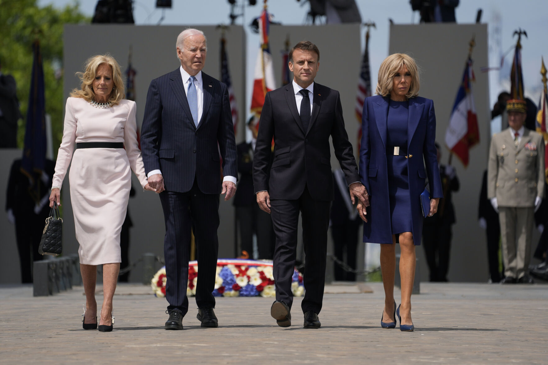 U.S. First Lady Jill, Biden, U.S. President Joe Biden, French President Emmanuel Macron and Brigitte Macron walk by the tomb of the Unknown soldier during a ceremony at the Arc de Triomphe, Saturday, June 8, 2024 in Paris. (AP Photo/Evan Vucci)    PHOTO CREDIT: Associated Press