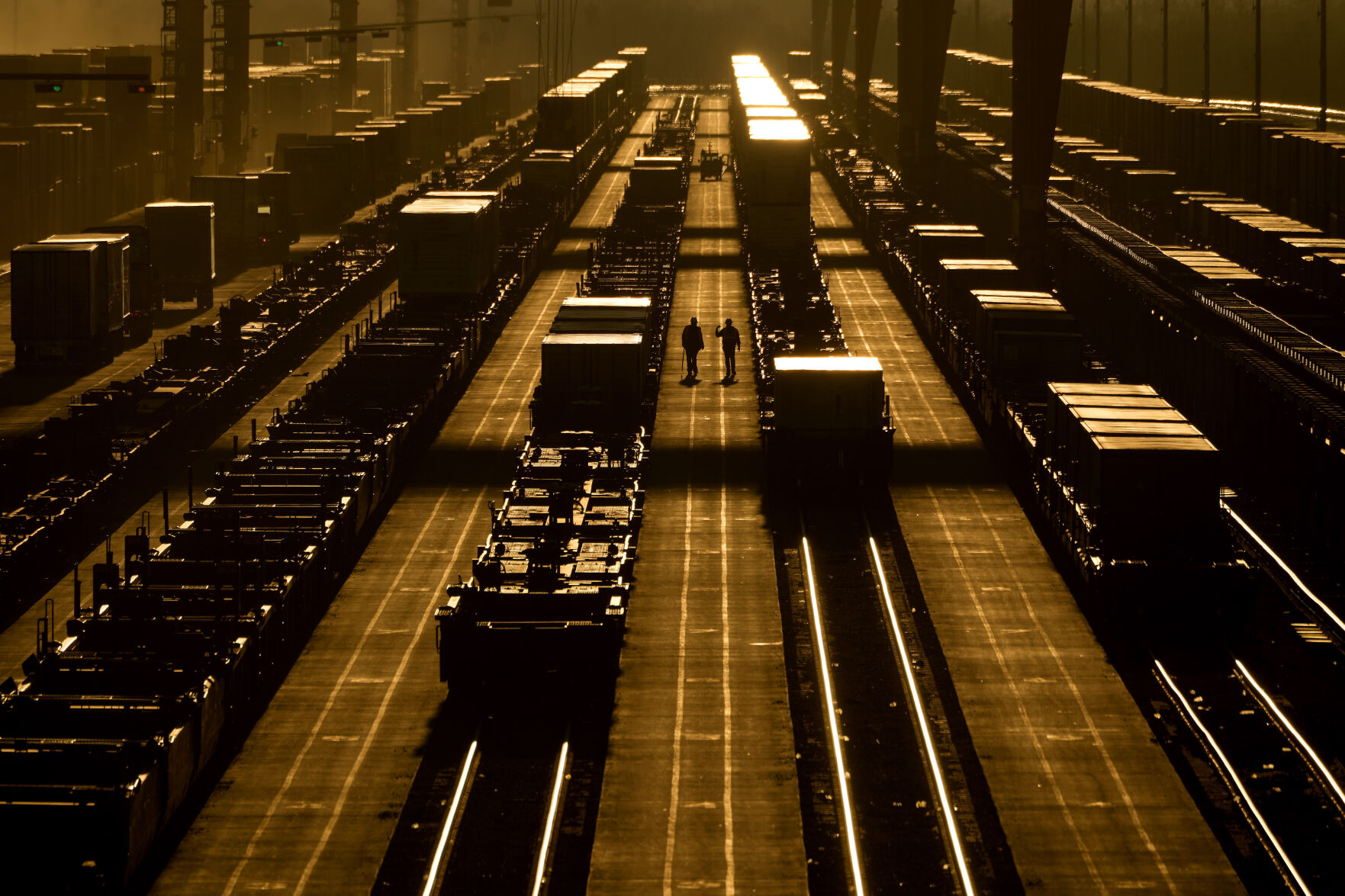 <p>FILE - Workers walk among shipping containers in a loading area at a BNSF intermodal terminal, Jan. 3, 2024, in Edgerton, Kan. The World Bank upgraded the outlook for the global economy in 2024, citing continued resilience and strength in the United States. (AP Photo/Charlie Riedel, File)</p>   PHOTO CREDIT: Charlie Riedel 