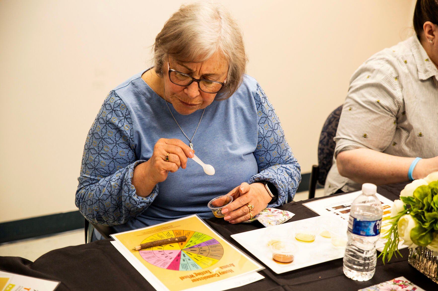 An attendee tries some honey during one of Dry Creek Beekeeping’s honey tastings at the Galena (Ill.) Art & Recreation Center.    PHOTO CREDIT: Contributed