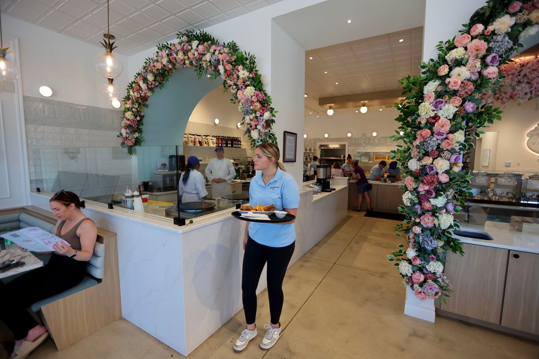 People enjoy their lunch inside Roses & Berries Cafe in Dubuque on Friday, June 14, 2024.    PHOTO CREDIT: Dave Kettering