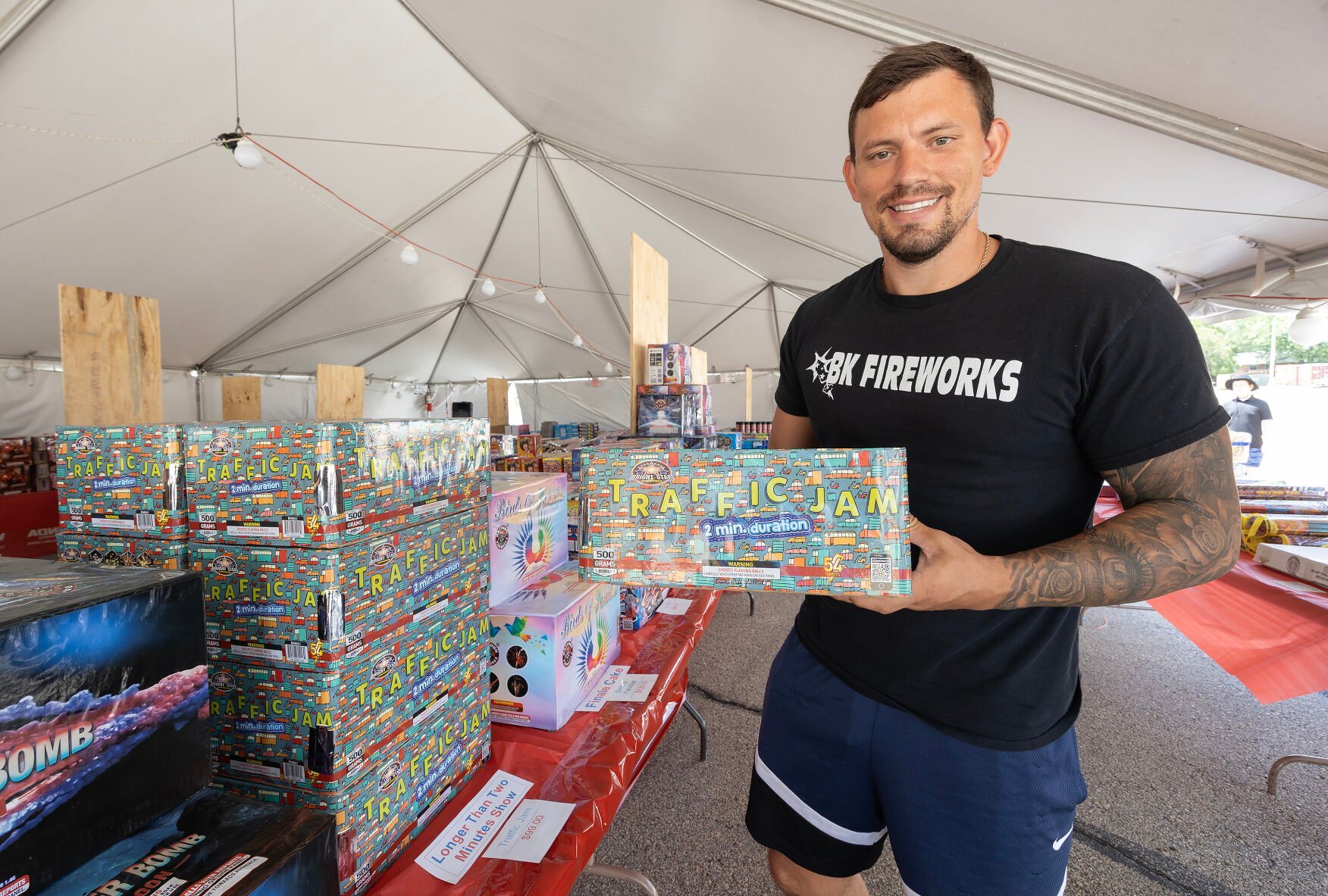 Owner Spencer Kohn holds fireworks available at his stand in Dubuque on Tuesday, June 18, 2024.    PHOTO CREDIT: Stephen Gassman