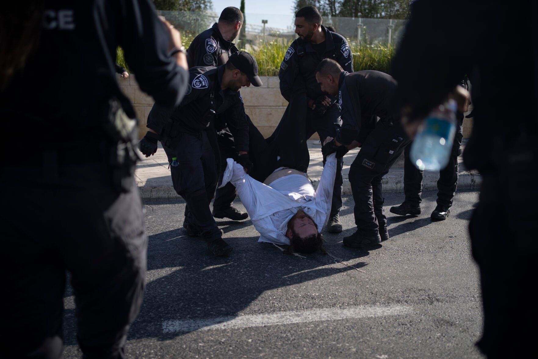 <p>FILE - Israeli police officers remove an ultra-Orthodox Jewish man from the street during a protest against army recruitment in Jerusalem on June 2, 2024. Israel’s Supreme Court on Tuesday, June 25, ruled unanimously that the military must begin drafting ultra-Orthodox men for military service, a decision that could lead to the collapse of Prime Minister Benjamin Netanyahu’s governing coalition as Israel continues to wage war in Gaza. (AP Photo/Leo Correa, File)</p>   PHOTO CREDIT: Leo Correa 