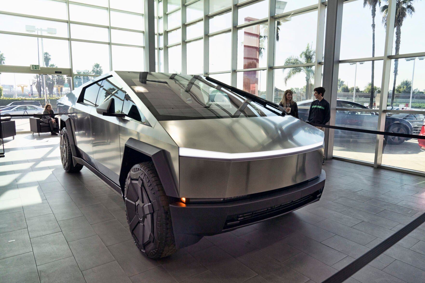 <p>FILE - A Tesla Cybertruck is on display at the Tesla showroom in Buena Park, Calif., Dec. 3, 2023. Tesla is recalling its futuristic new Cybertruck pickup for the fourth time in the U.S. to fix problems with trim pieces that can come loose and front windshield wipers that can fail. The new recalls, announced in documents posted Tuesday, June 25, 2024, by the National Highway Traffic Safety Administration, each affect more than 11,000 trucks. (AP Photo/Richard Vogel, File)</p>   PHOTO CREDIT: Richard Vogel 