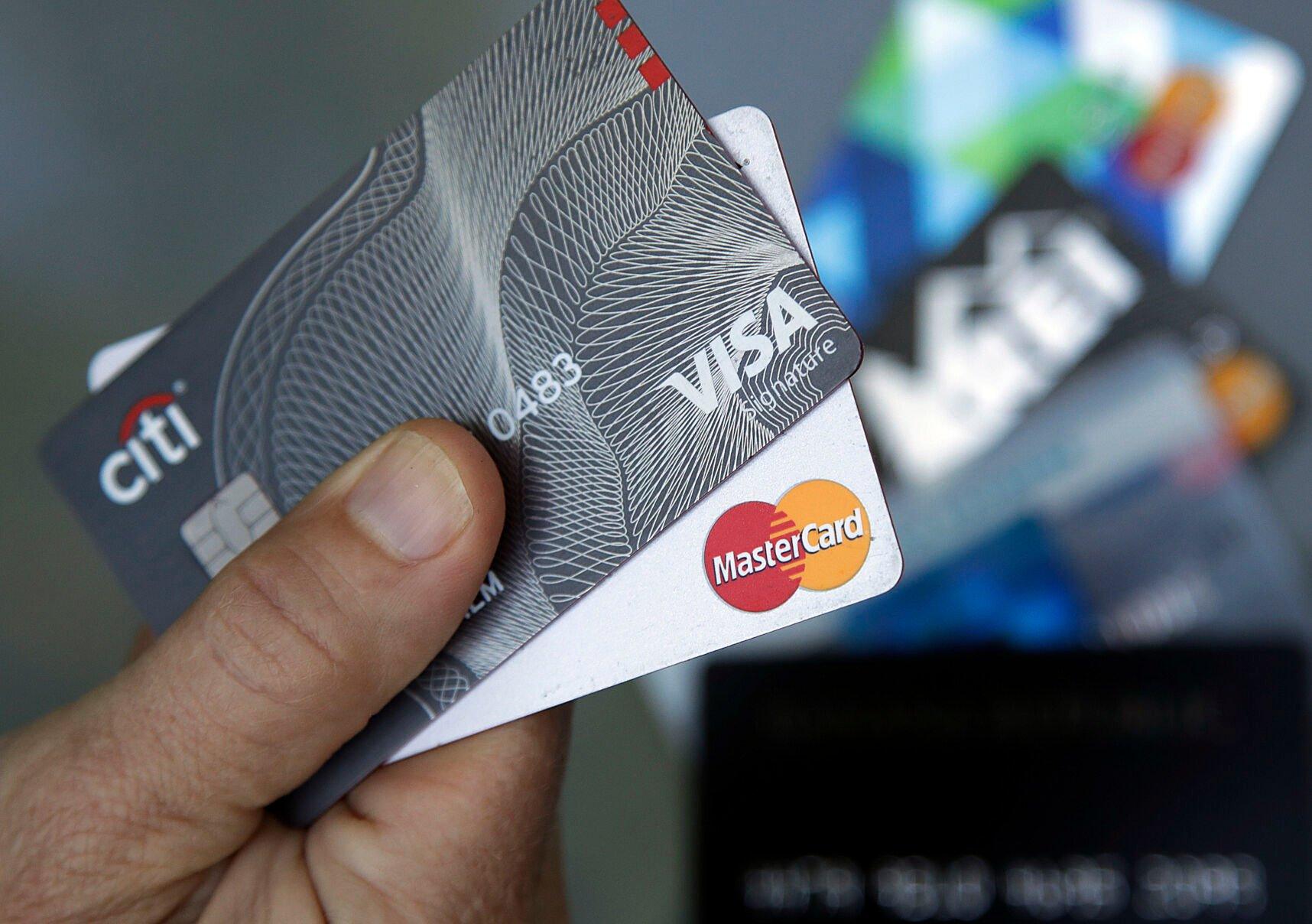 <p>FILE- An unnamed person holds two Visa and Mastercard credit cards in Haverhill, Mass., June 15, 2017. Judge Margo Brodie of the Eastern District of New York said she’s not likely to approve the $30 billion settlement between Visa and Mastercard and merchants who say they’ve overpaid on swipe fees. (AP Photo/Elise Amendola, File)</p>   PHOTO CREDIT: Elise Amendola 