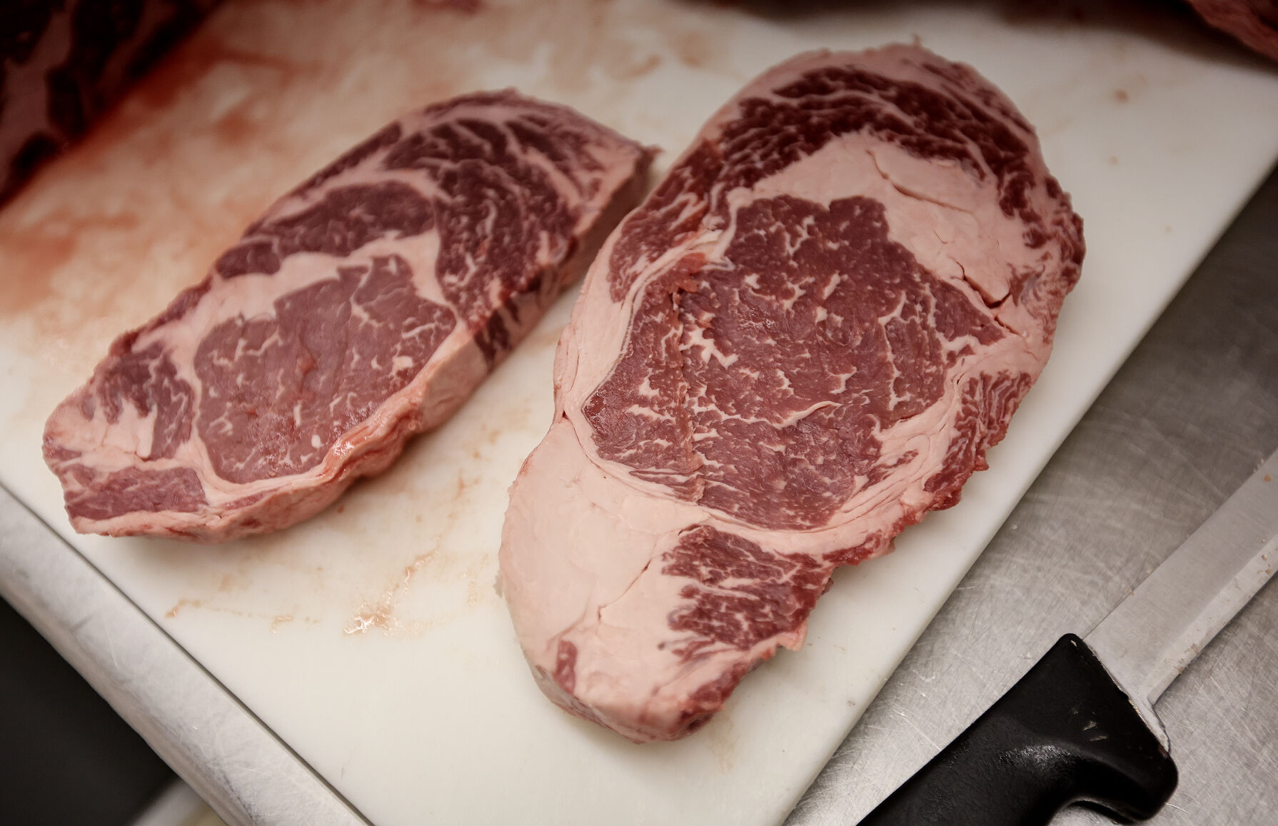 Jeff Cremer says the marbling in the meat is something to look for when shopping for a quality steak at Cremer’s in Dubuque.    PHOTO CREDIT: Dave Kettering/Telegraph Herald