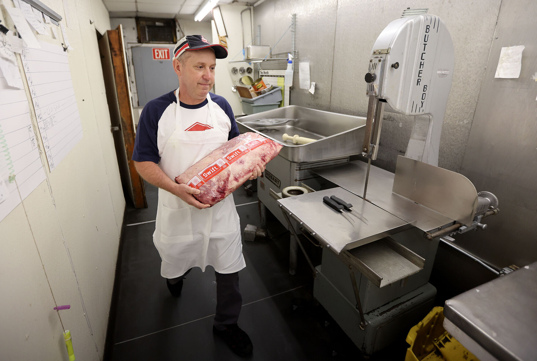 Jeff Cremer carries a slab of prime meat to be cut and offered for sale inside Cremer’s in Dubuque.    PHOTO CREDIT: Dave Kettering/Telegraph Herald