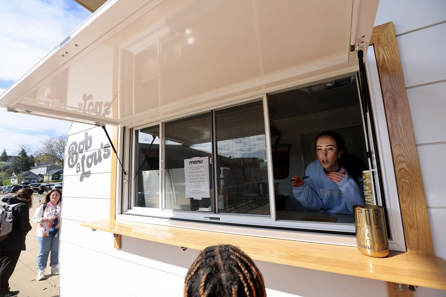 Sarah Knabel takes a customer’s order at the Bob & Lou’s Coffee Camper on the Loras College campus.    PHOTO CREDIT: File photo