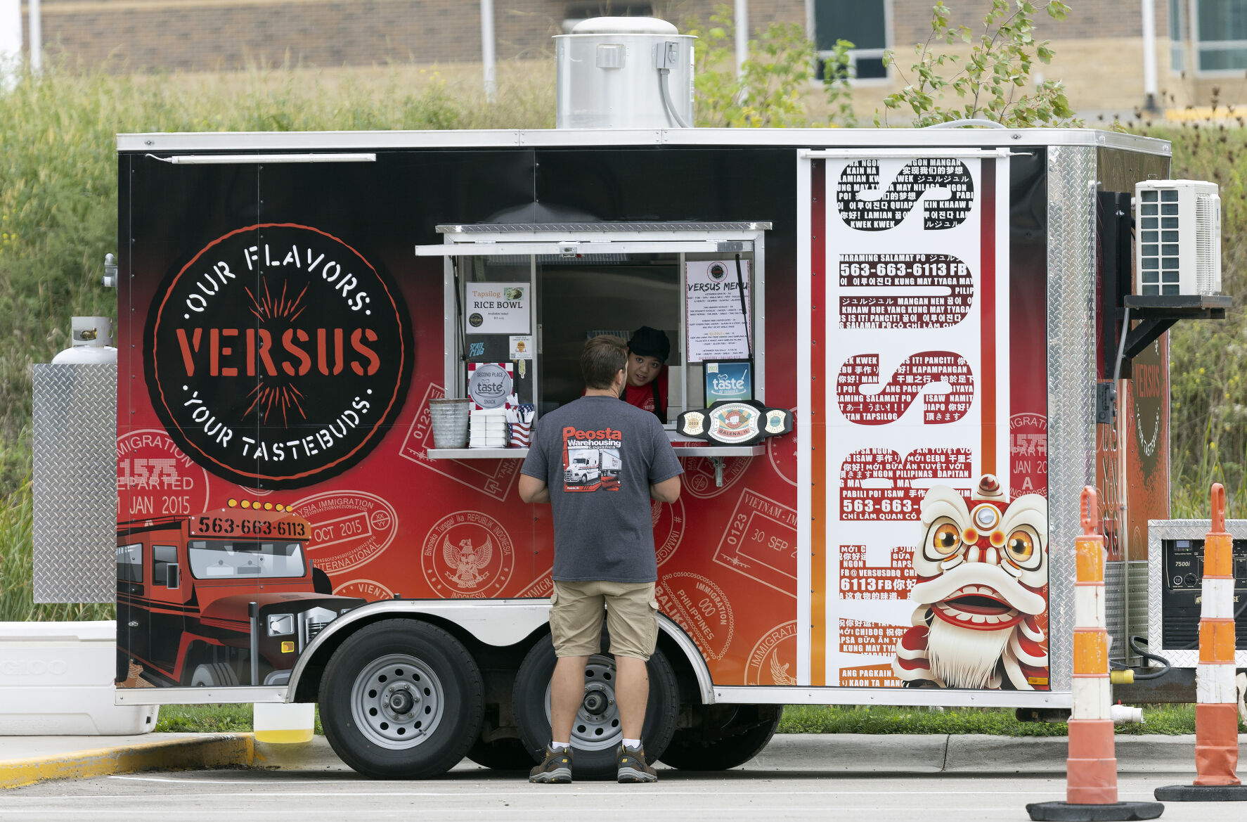 Versus food truck co-owner Liberty Miller takes an order while parked in a lot in Peosta, Iowa, on Friday, Sept. 22, 2023.    PHOTO CREDIT: File photo
