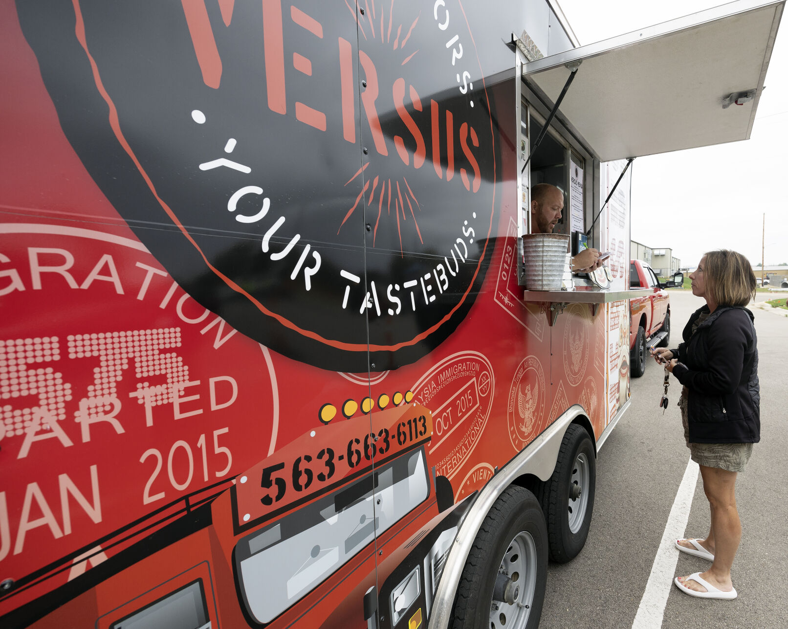 Versus food truk co-owner Lucas Miller takes an order from Denise Simms while it is parked at a lot in Peosta, Iowa on Friday, Sept. 22, 2023.    PHOTO CREDIT: File photo