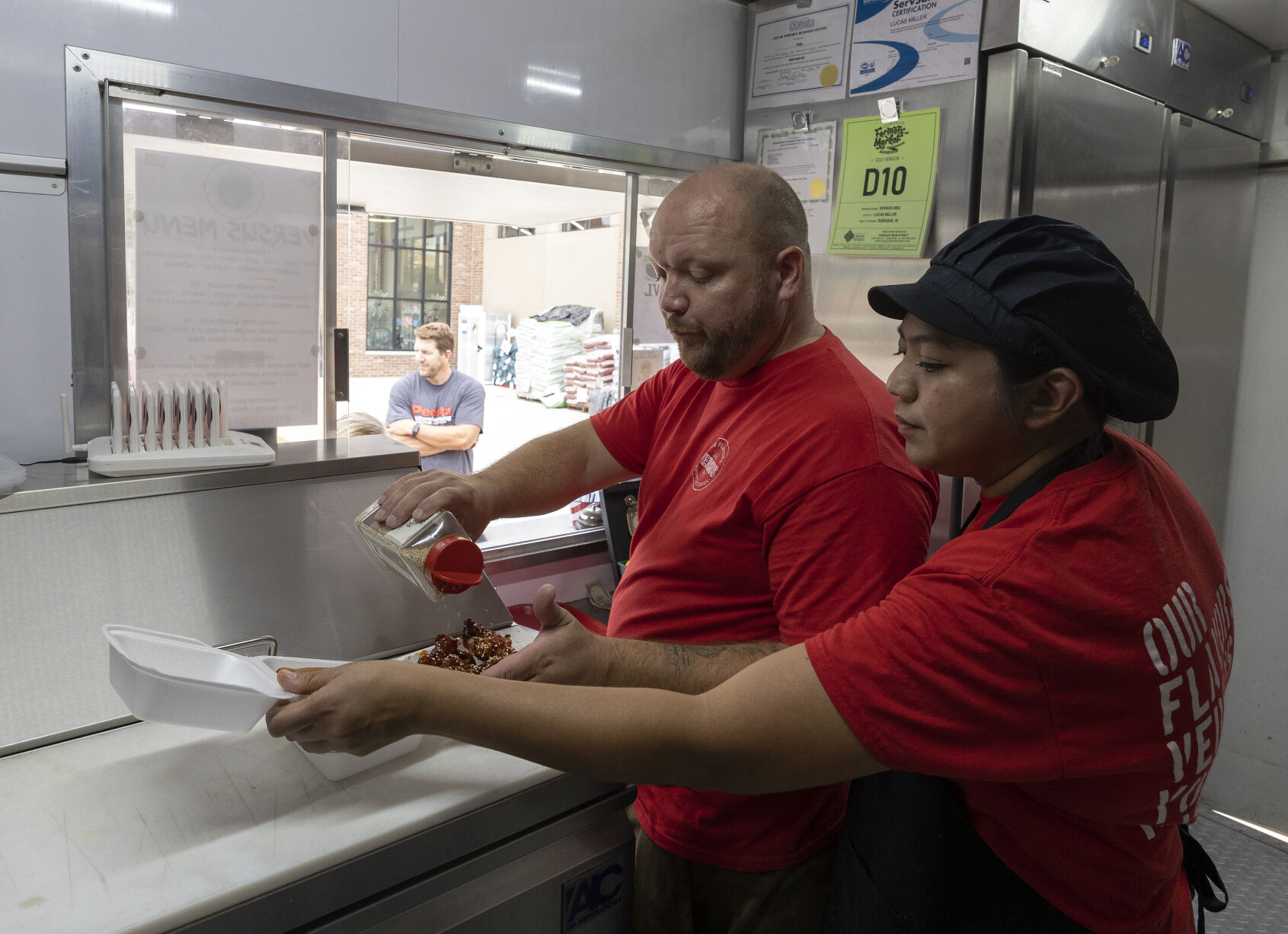 Versus food truck co-owners Lucas and Liberty Miller prepare an order while parked in a lot in Peosta, Iowa, on Friday, Sept. 22, 2023.    PHOTO CREDIT: File photo