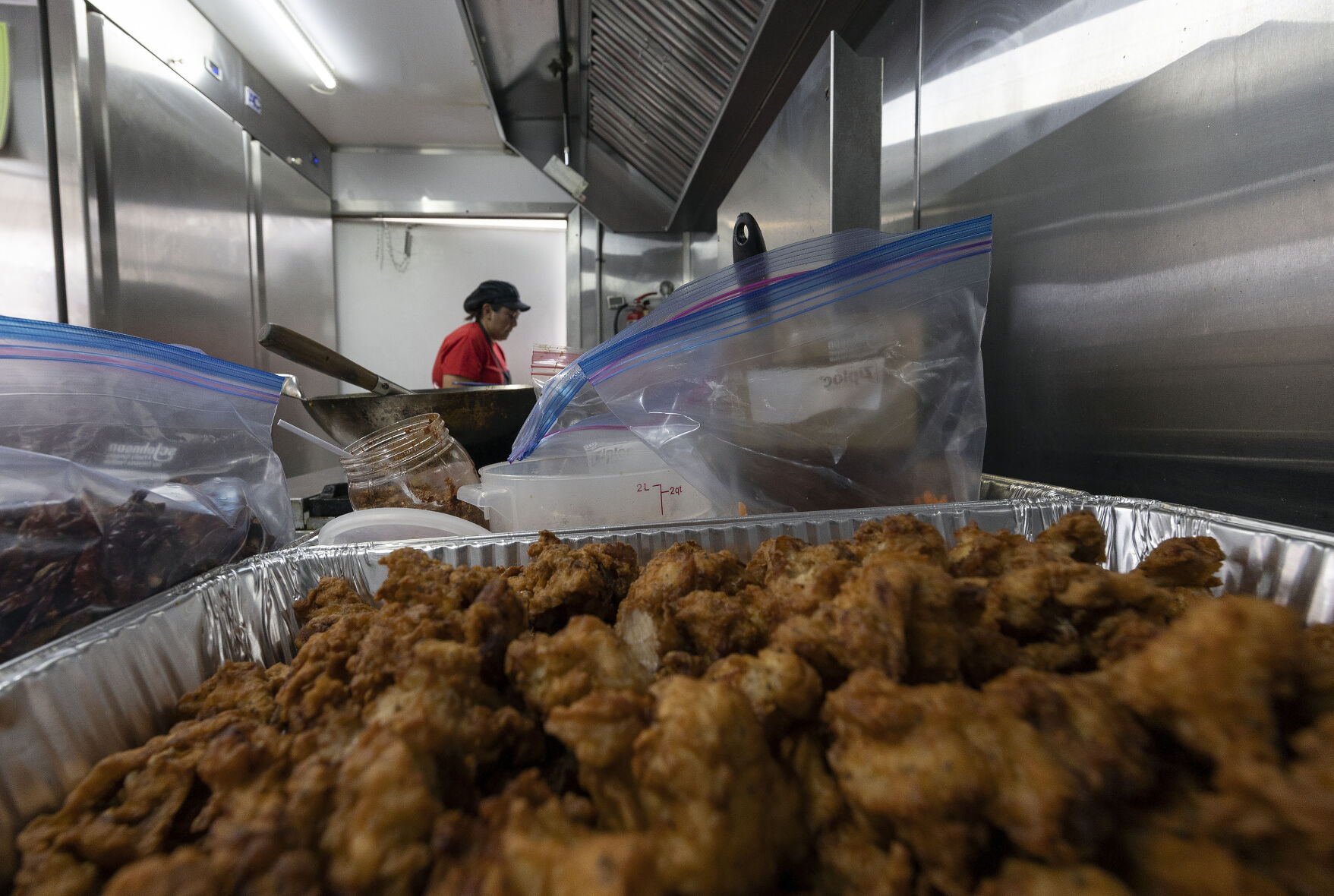 Versus food truck co-owner Liberty Miller prepares an order while parked in a lot in Peosta, Iowa, on Friday, Sept. 22, 2023.    PHOTO CREDIT: File photo