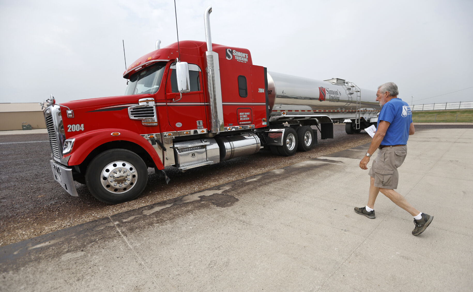 Driver Phil Birkil walks to his truck at Simon’s Trucking in Farley, Iowa.    PHOTO CREDIT: File photo