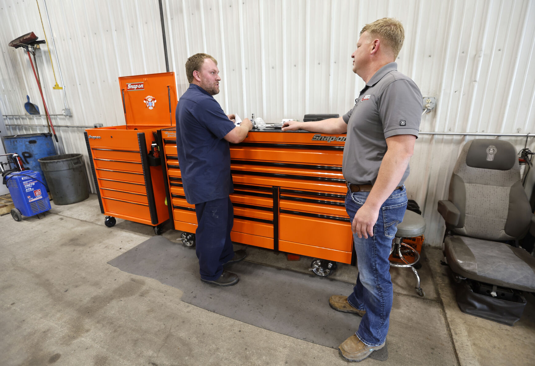 Owner Justin Philipp (right) talks with Cody Olson at Simon