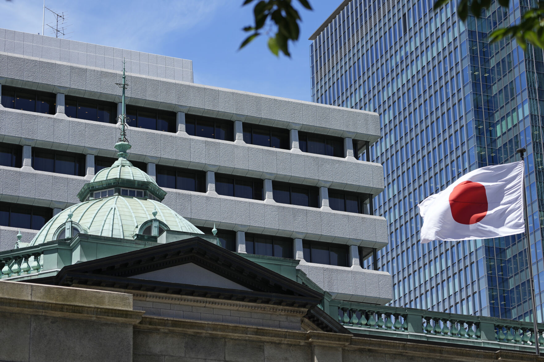 <p>FILE - A Japanese flag flutters at the Bank of Japan headquarters in Tokyo, Thursday, July 29, 2022. Japan revised its earlier estimates to show that its economy contracted at a 2.9% annual pace in the first quarter of the year, as meanwhile a survey by the central bank released Monday, July 1, 2024, showed conditions remain sluggish. (AP Photo/Shuji Kajiyama, File)</p>   PHOTO CREDIT: Shuji Kajiyama