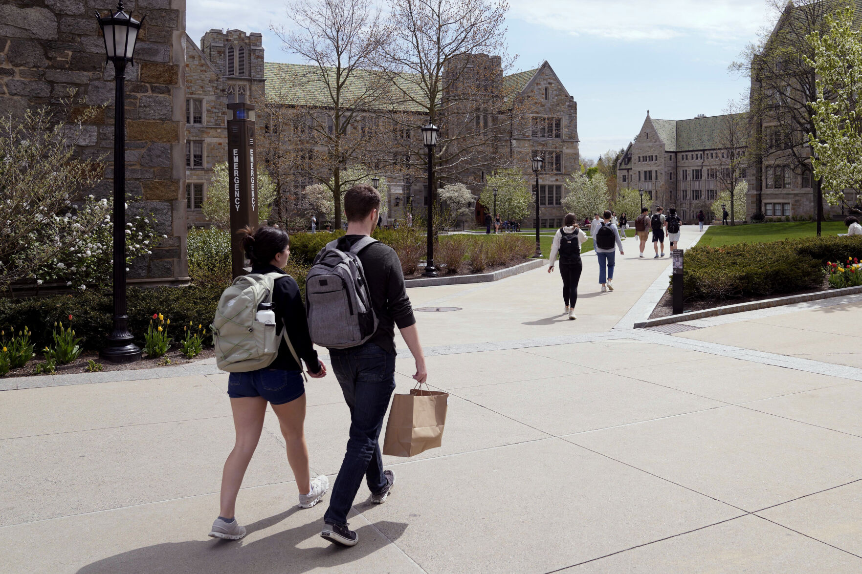 <p>FILE - Students walk on the campus of Boston College, Monday, April 29, 2024, in Boston. Americans are increasingly skeptical about the value and cost of college, with most saying they feel the U.S. higher education system is headed in the “wrong direction,” according to a new poll. (AP Photo/Charles Krupa, File)</p>   PHOTO CREDIT: Charles Krupa