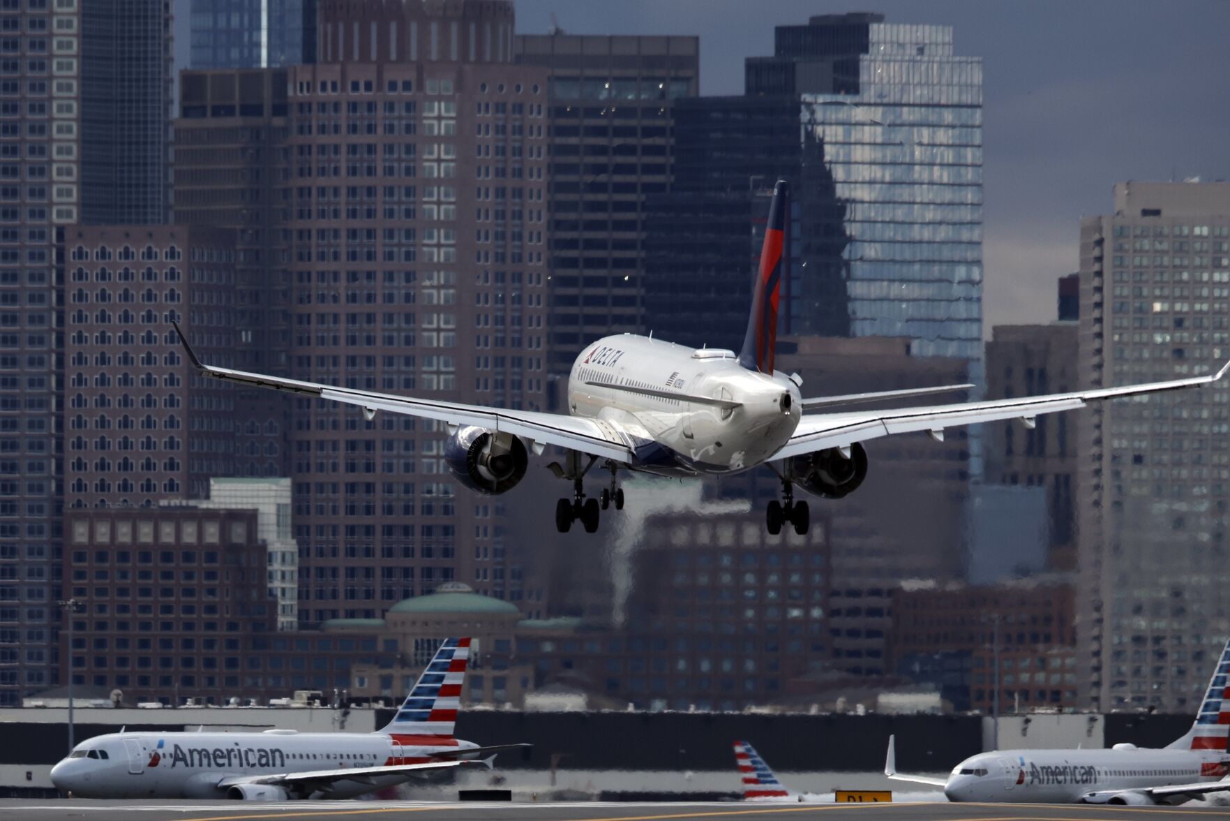 FILE - A Delta Air Lines plane lands at Logan International Airport, Thursday, Jan. 26, 2023, in Boston. On July 11, 2024, Delta Air Lines said its second-quarter profit is down 29% from a year earlier, and it