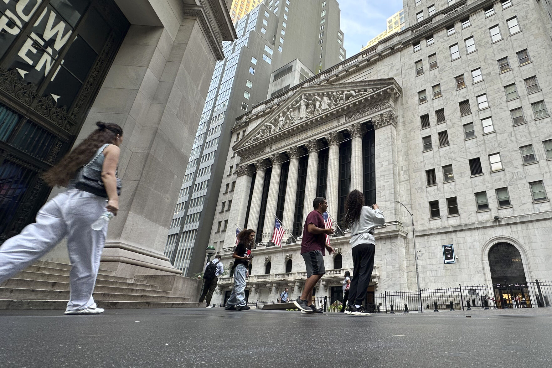 <p>FILE - People pass the New York Stock Exchange July 10, 2024, in New York. World shares began trading mixed on Monday, July 15, 2024, after China reported that its economy expanded at a lower-than-forecast 4.7% annual pace in the last quarter. (AP Photo/Peter Morgan, File)</p>   PHOTO CREDIT: Peter Morgan - staff, ASSOCIATED PRESS