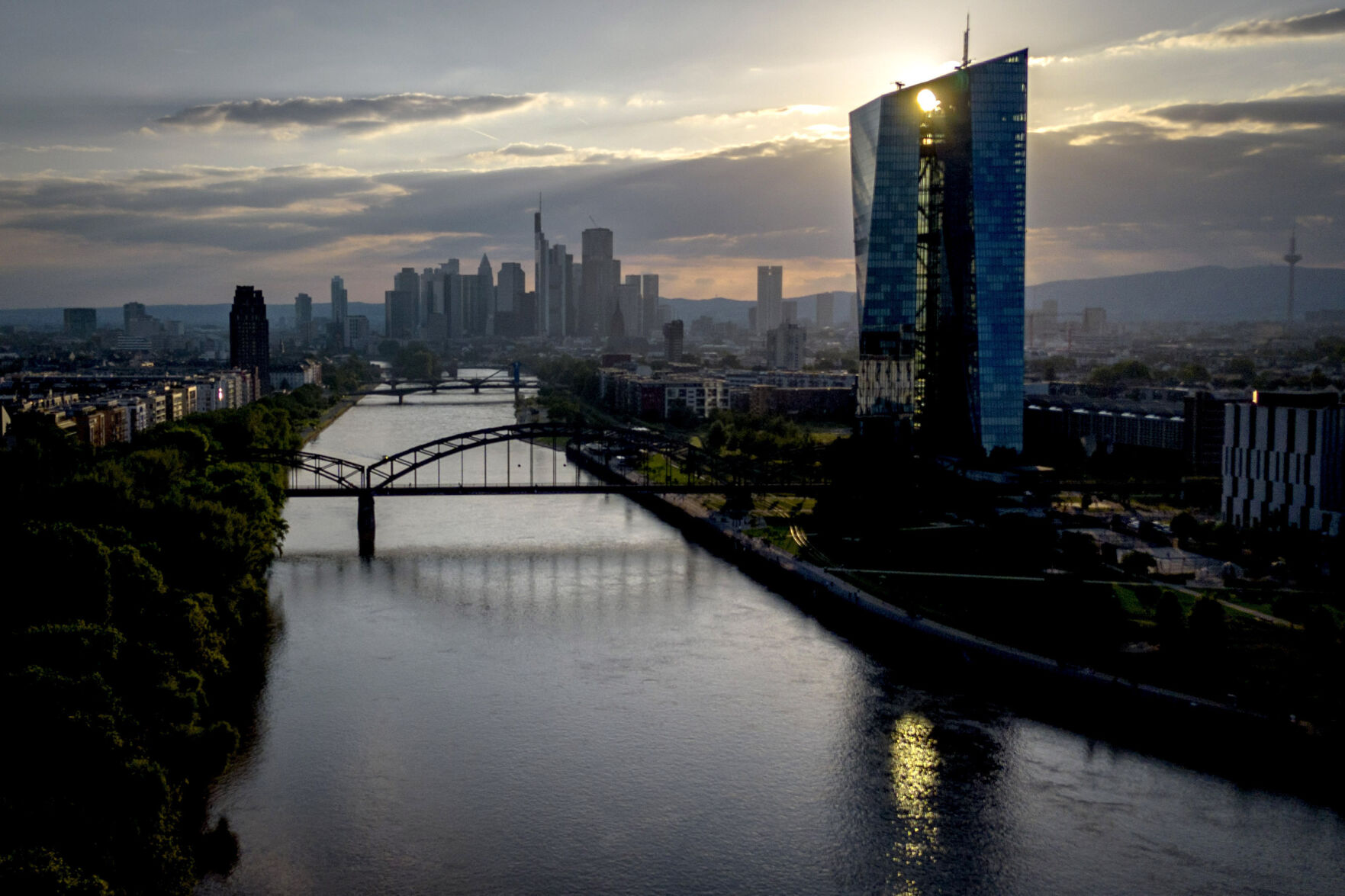 <p>FILE - The sun sets behind the European Central Bank in Frankfurt, Germany, June 4, 2024. Home buyers and businesses waiting for lower interest rates in Europe are going to have to wait a little longer as the ECB takes its time to make sure stubborn inflation is firmly under control before lowering its benchmark rate again. (AP Photo/Michael Probst, File)</p>   PHOTO CREDIT: Michael Probst - staff, ASSOCIATED PRESS