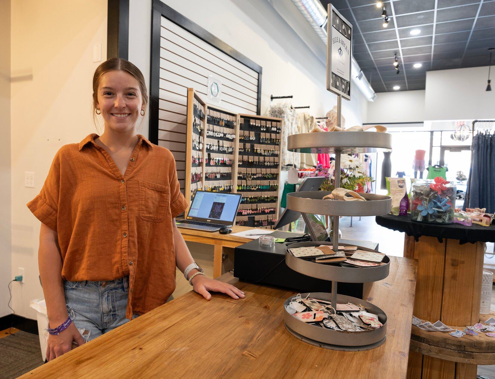 Associate Emma Oberbroeckling stands at the counter at Elle & Beck’s Lifestyle Boutique in Dyersville, Iowa.    PHOTO CREDIT: Gassman