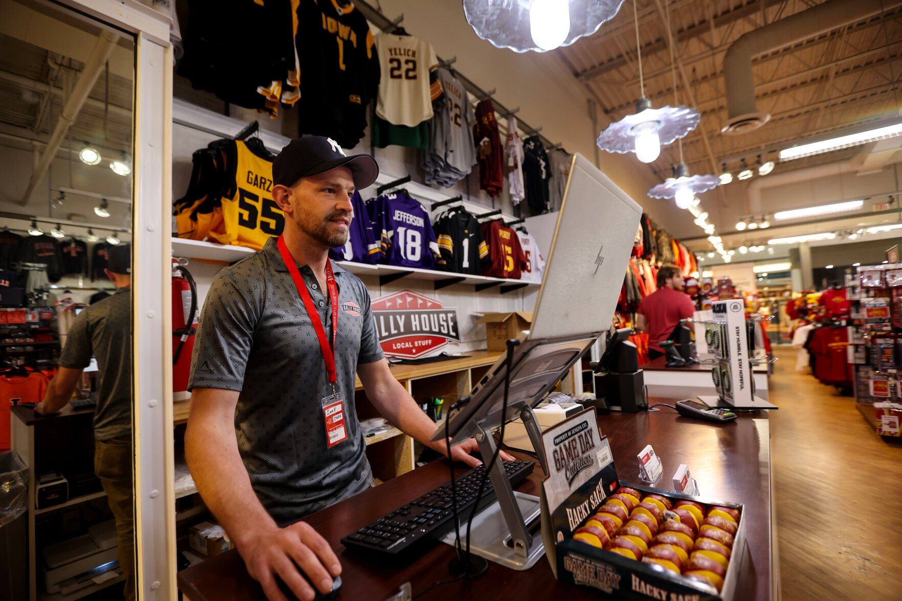 Rally House store manager Ian Van Gilder works at the Kennedy Mall location in Dubuque on Saturday.    PHOTO CREDIT: Dave Kettering