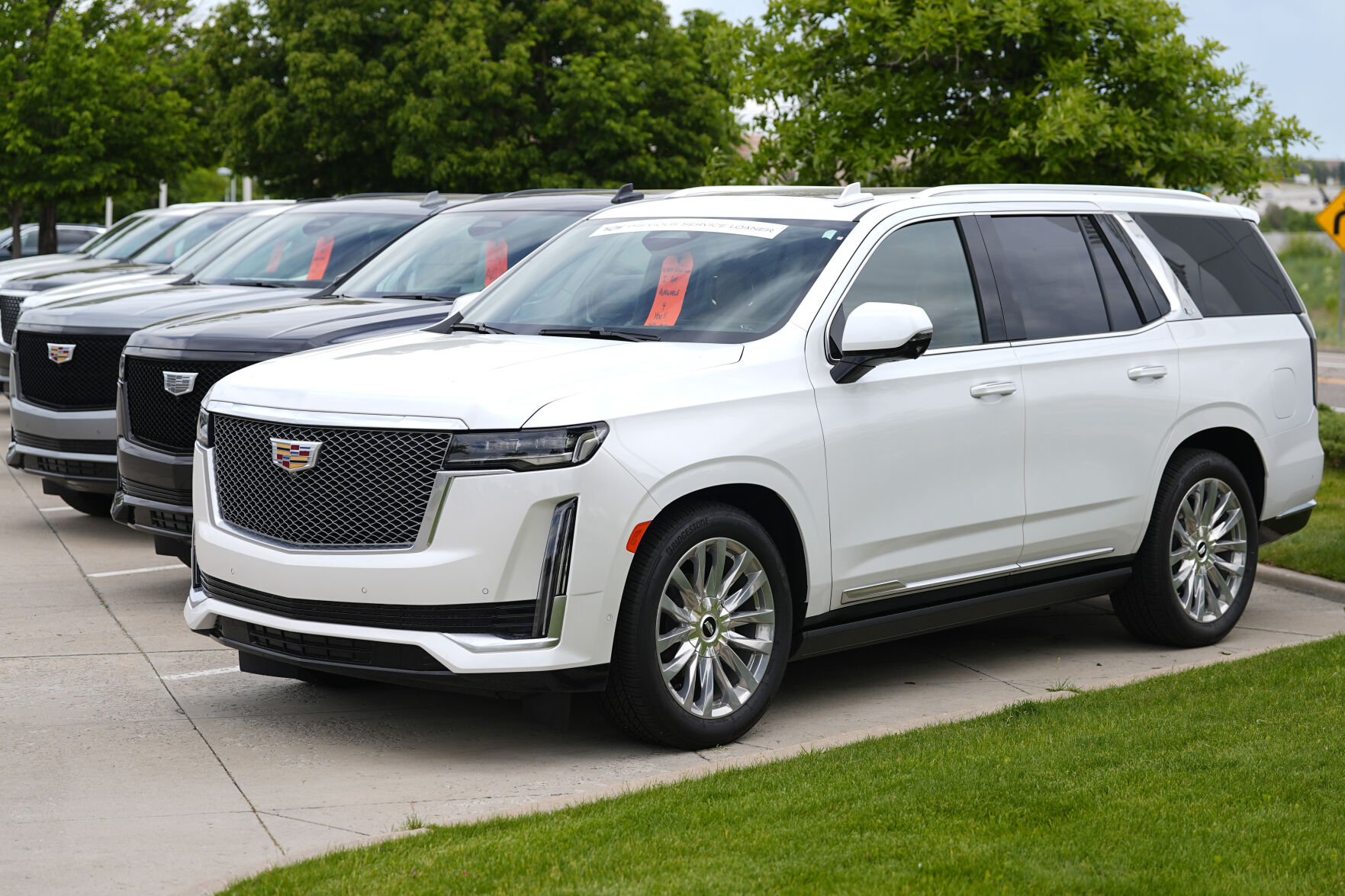 <p>FILE - Unsold 2024 Escalade utility vehicles sit in a row outside a Cadillac dealership on June 2, 2024, in Lone Tree, Colo. General Motors reports earnings on Tuesday, July 23, 2024. (AP Photo/David Zalubowski, File)</p>   PHOTO CREDIT: David Zalubowski 