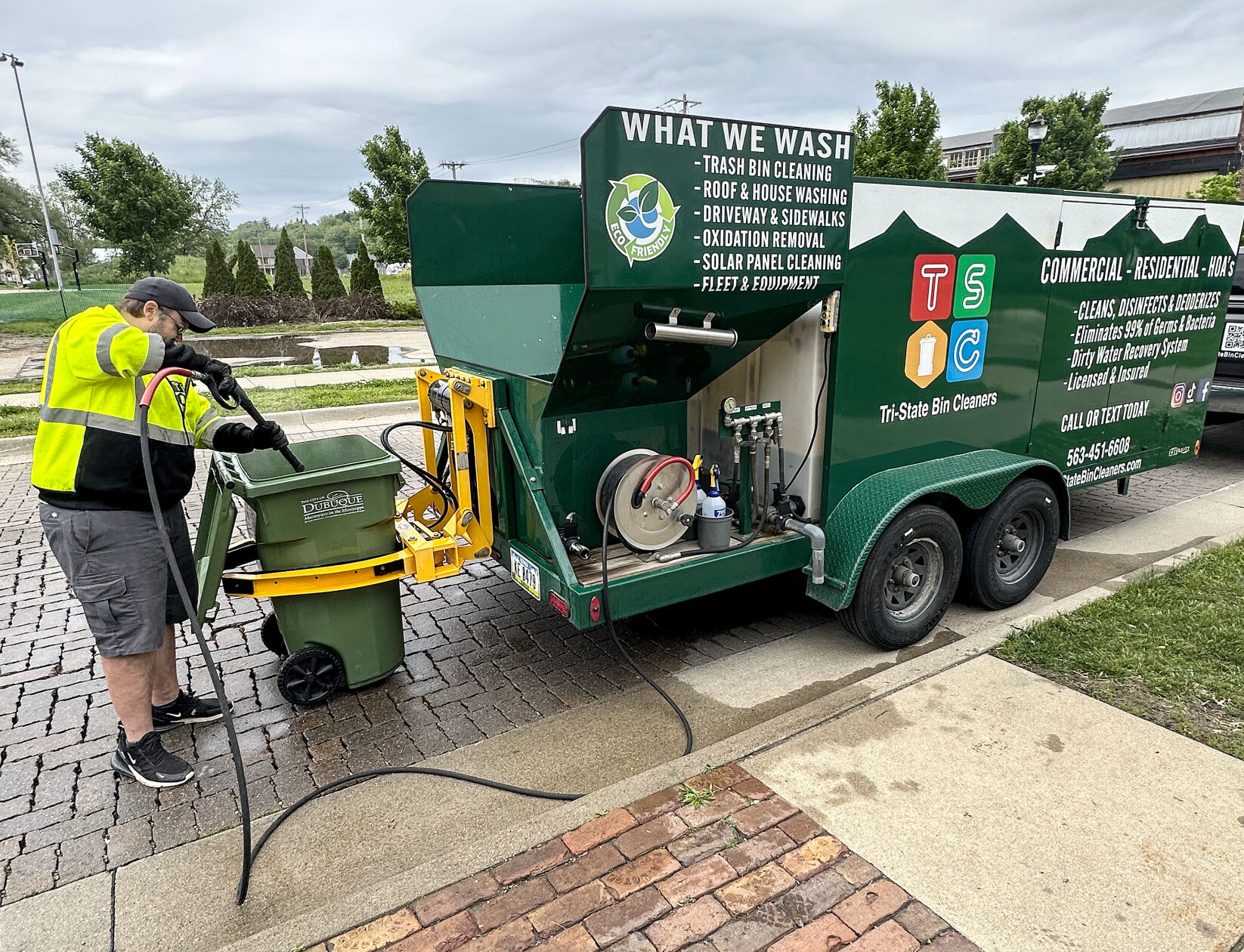 Jeff Gedmin cleans trash cans for Tri-State Bin Cleaners & Power Washing recently.    PHOTO CREDIT: Contributed