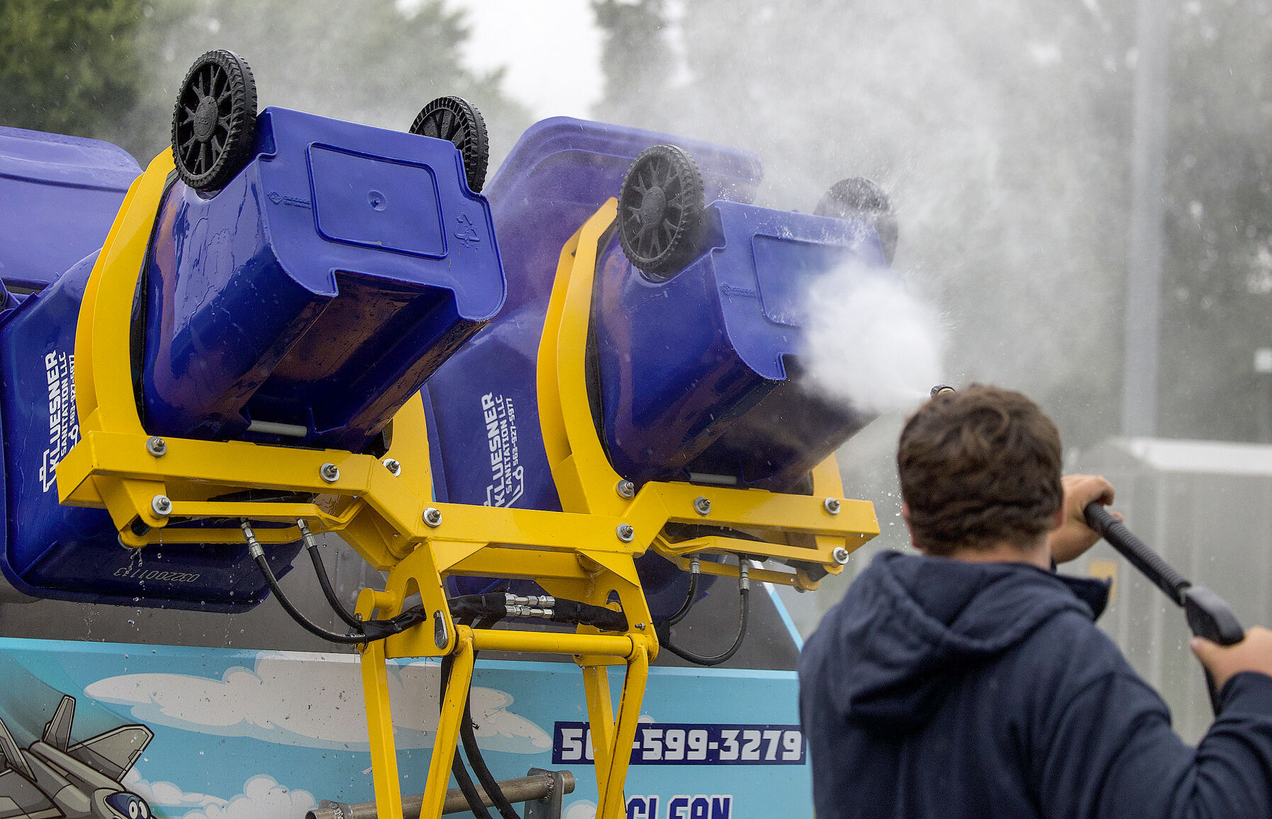 Bodee Pitts, of Top Gun Can Cleaning, on the job in Farley, Iowa.    PHOTO CREDIT: Sophia Bitter Telegraph Herald