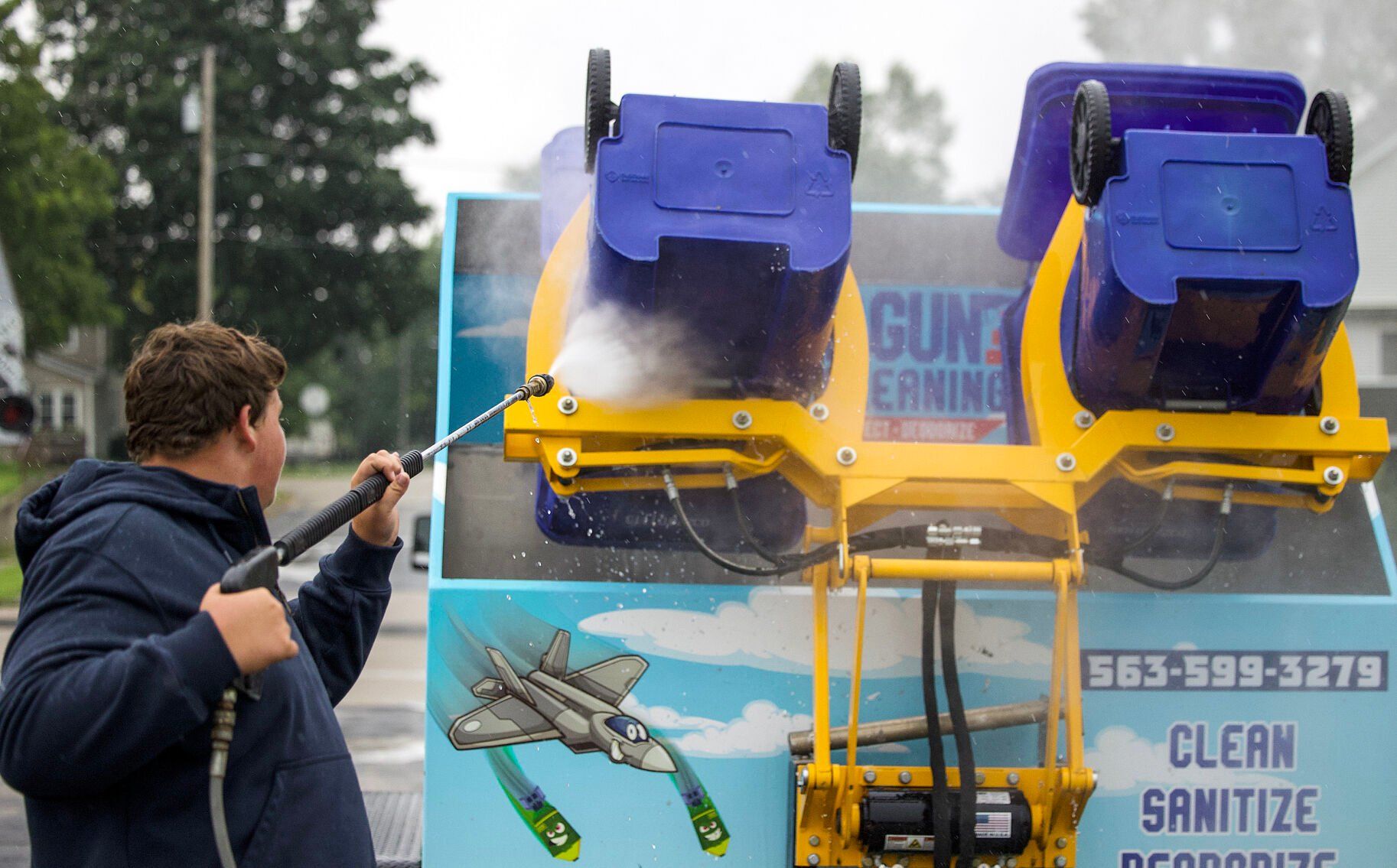 Bodee Pitts, of Top Gun Can Cleaning, completes a job in Farley, Iowa.    PHOTO CREDIT: Sophia Bitter Telegraph Herald