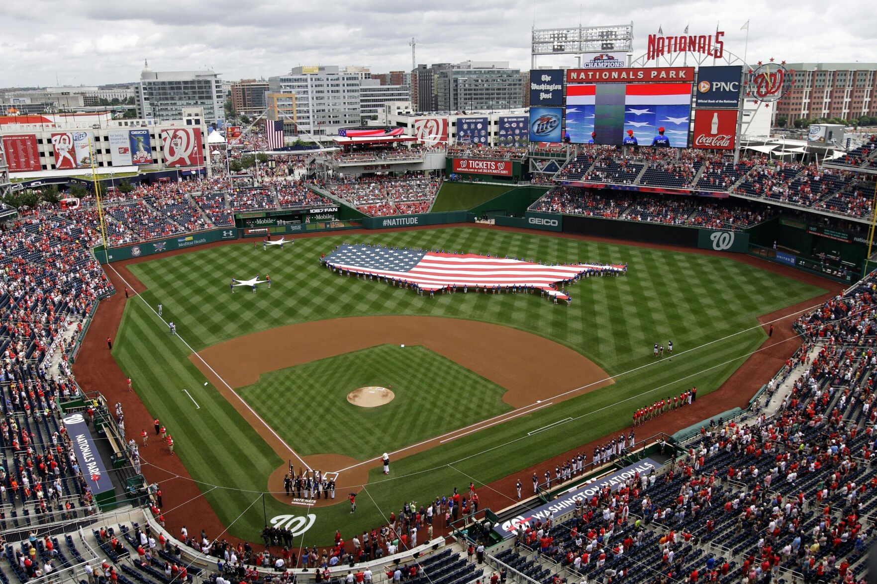 FILE - This July 4, 2013, file photo shows a U.S. flag, in the shape of the country, in the outfield before a baseball game between the Washington Nationals and the Milwaukee Brewers at Nationals Park in Washington. The attorney general for Washington, D.C. has sued StubHub, accusing the ticket resale platform of advertising deceptively low prices and then ramping up prices with extra fees. Attorney General Brian Schwalb said Wednesday the practice known as drip pricing violates consumer protection laws in the nation’s capital. The lawsuit says StubHub has sold nearly 5 million tickets in Washington since implementing the practice in 2015 and reaped about $118 million in fees. (AP Photo/Mark Tenally, File)    PHOTO CREDIT: Associated Press