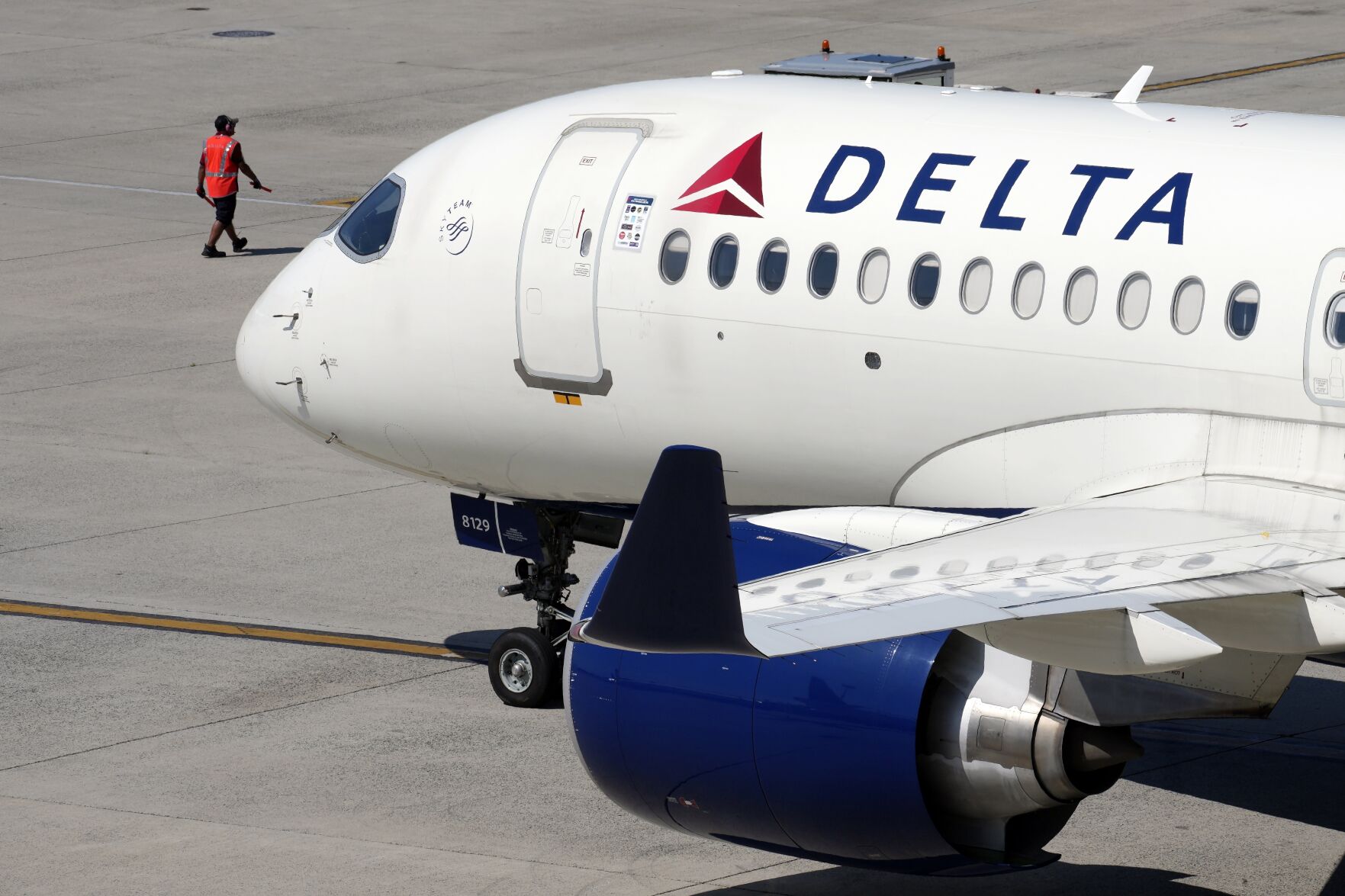 FILE - A Delta Air Lines jet leaves the gate, July 19, 2024, at Logan International Airport in Boston. Delta CEO Ed Bastian says the airline is facing $500 million in costs for the global technology breakdown that happened earlier this month. (AP Photo/Michael Dwyer, File)    PHOTO CREDIT: Associated Press