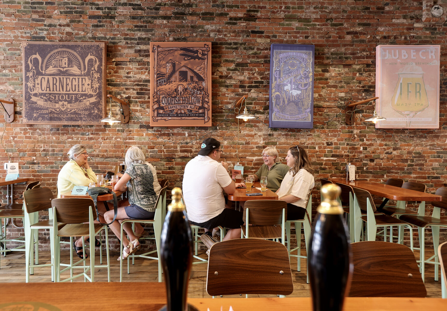 People chat inside Jubeck New World Brewing in Dubuque.    PHOTO CREDIT: Dave Kettering