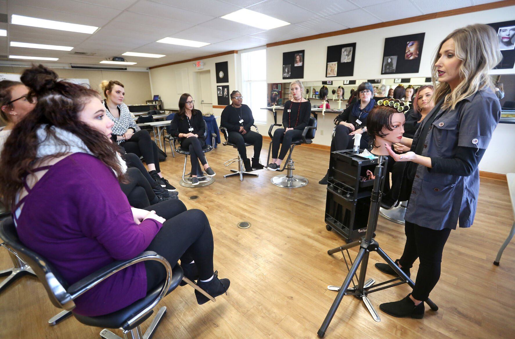 Capri College instructor Corinne Hurst explains roller placement to students during a class.    PHOTO CREDIT: File photo