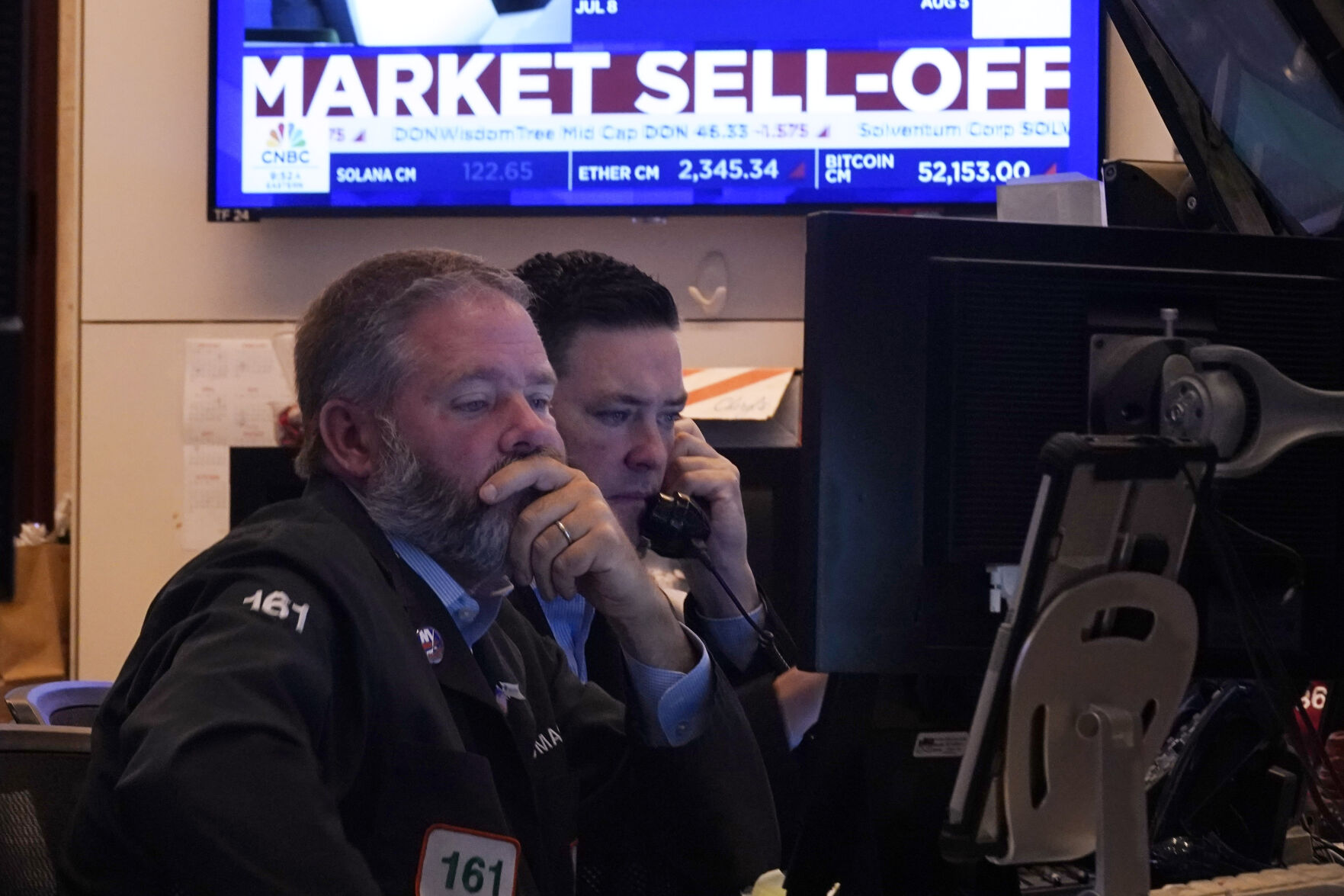 A pair of traders work on the floor of the New York Stock Exchange, Monday, Aug. 5, 2024. Nearly everything on Wall Street is tumbling as fear about a slowing U.S. economy worsens and sets off another sell-off for financial markets around the world. (AP Photo/Richard Drew)    PHOTO CREDIT: Associated Press