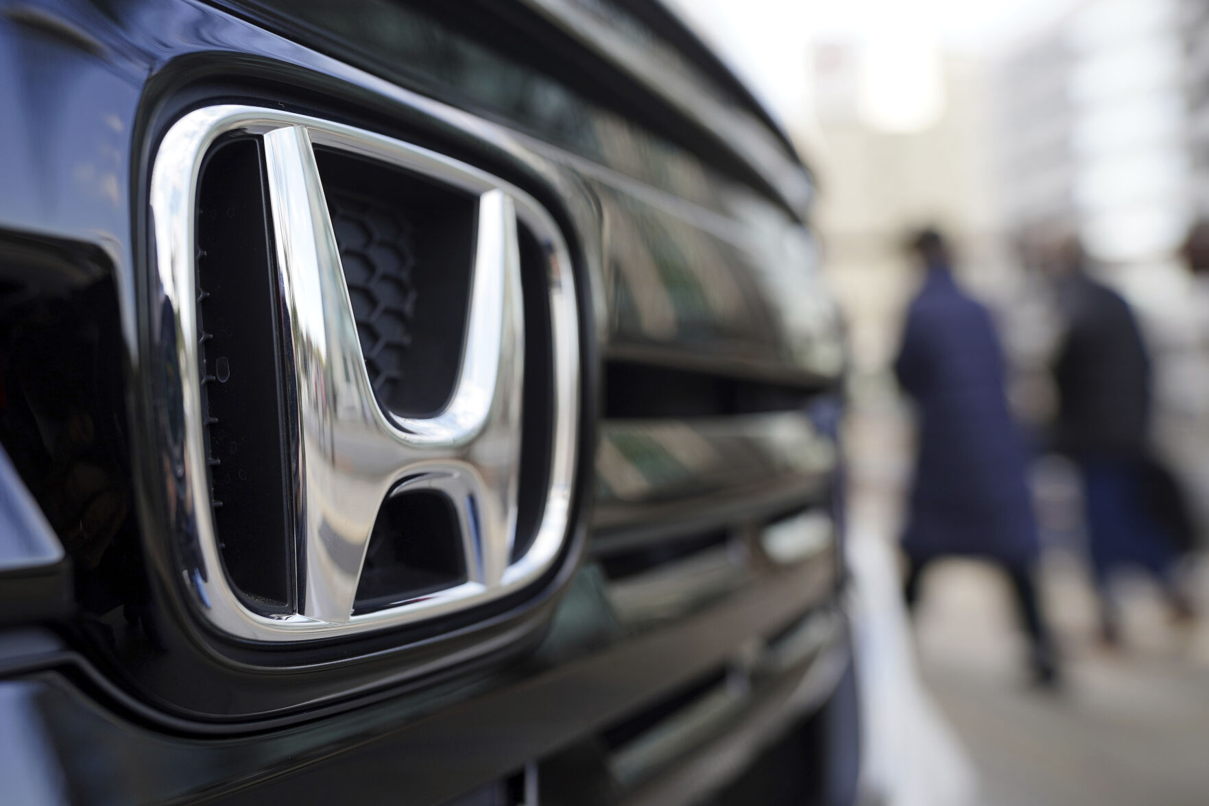 <p>FILE - People walk near the logo of Honda Motor Company at a showroom on Feb. 8, 2022, in Tokyo. (AP Photo/Eugene Hoshiko, File)</p>   PHOTO CREDIT: Eugene Hoshiko 