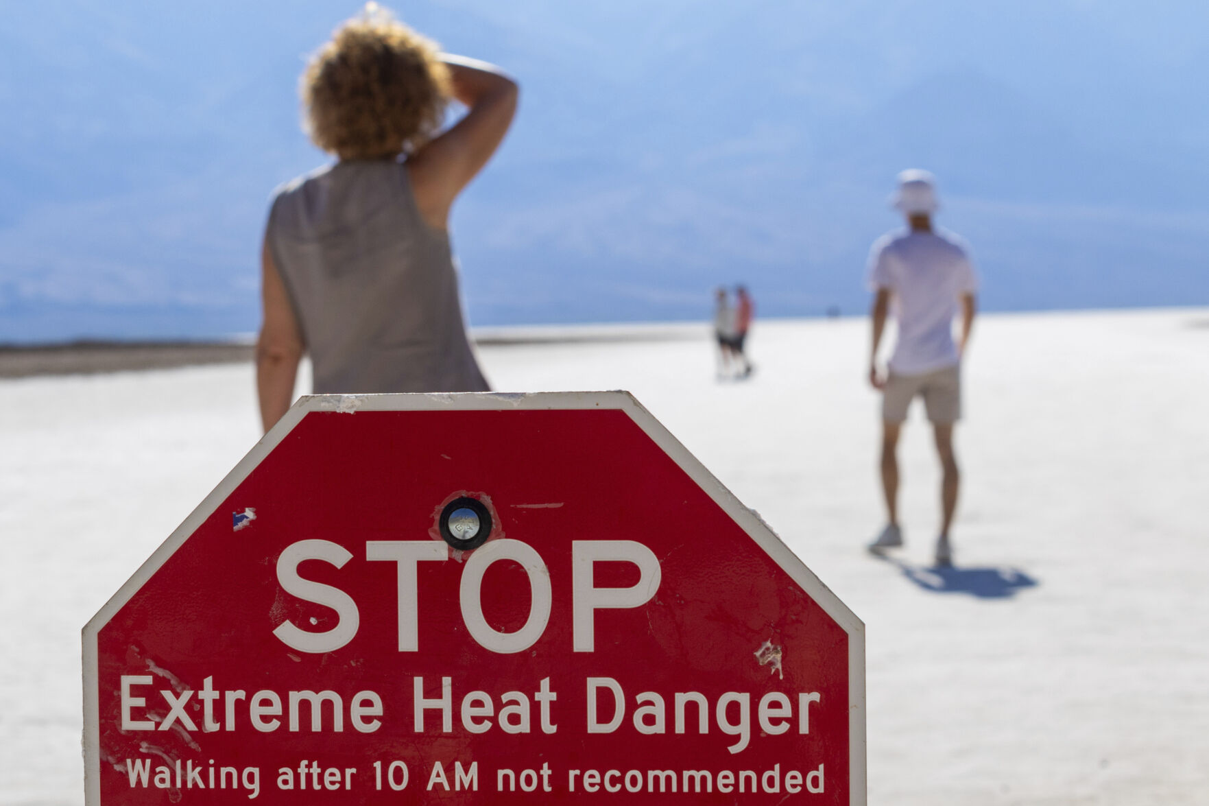 <p>FILE - A person wipes sweat from their brow at Badwater Basin in Death Valley National Park, Calif., July 7, 2024. (AP Photo/Ty ONeil, File)</p>   PHOTO CREDIT: TY ONEIL 