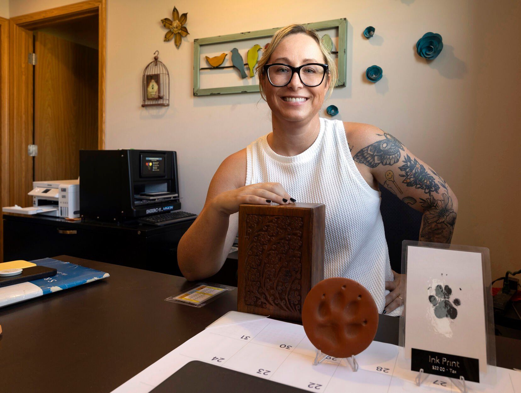 Co-owner Megan Schmitt sits at the front desk of S&S Pet Cremation in Centralia, Iowa.    PHOTO CREDIT: Stephen Gassman/Telegraph Herald