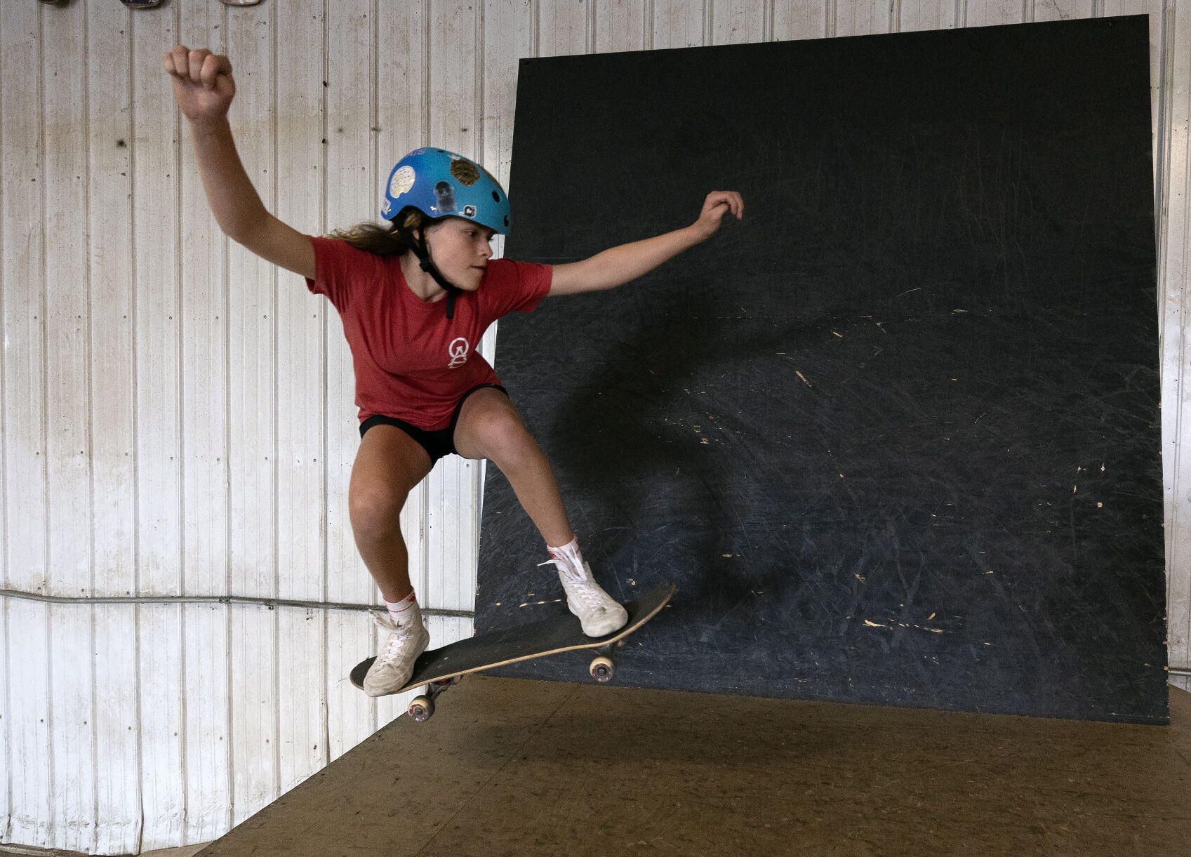 Elliana Gottschalk, 12, rides her skateboard at Olliewood Action Sports in Dubuque.    PHOTO CREDIT: Stephen Gassman