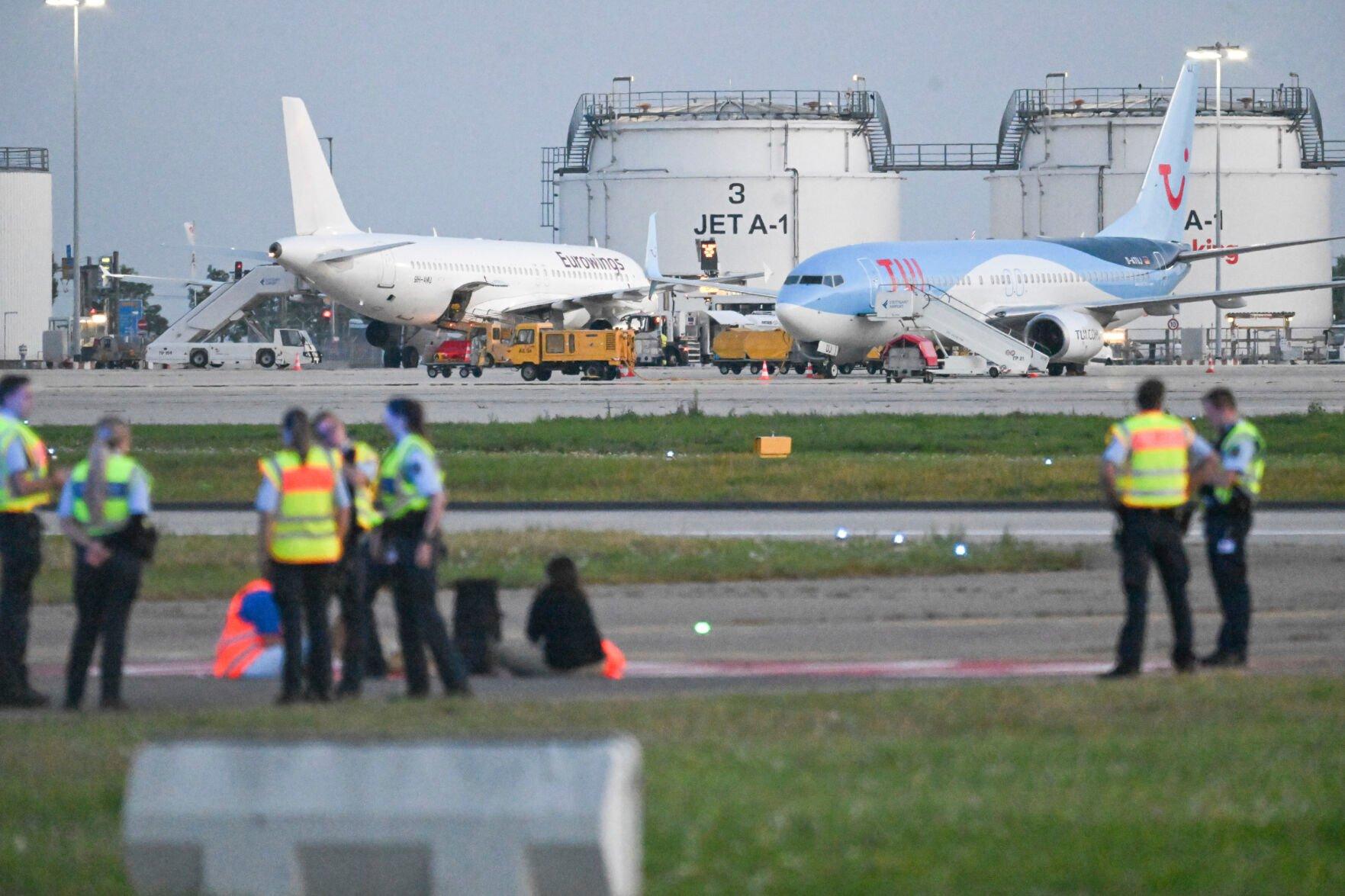 <p>Police on the tarmac at Stutgart airport, as climate activists staged protests at several German airports on Thursday, Aug. 15, 2024, forcing a temporary halt to flights at some of them in the latest of a string of similar demonstrations. The Last Generation group said that a total of eight activists were involved in the protests at Berlin, Cologne-Bonn, Nuremberg and Stuttgart airports, which started around 5 a.m. (Marius Bulling/dpa via AP)</p>   PHOTO CREDIT: Marius Bulling 