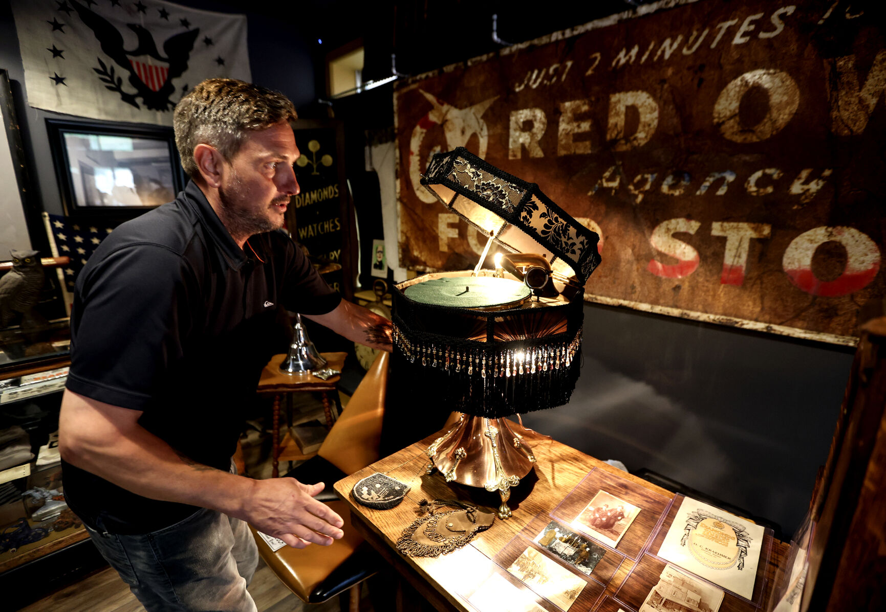 Clifford Blanck, co-owner of White Rooster Antiques, demonstrates one of his rarest collectables a lampshade phonograph in Galena, Ill., on Thursday, Aug. 15, 2024.    PHOTO CREDIT: Dave Kettering